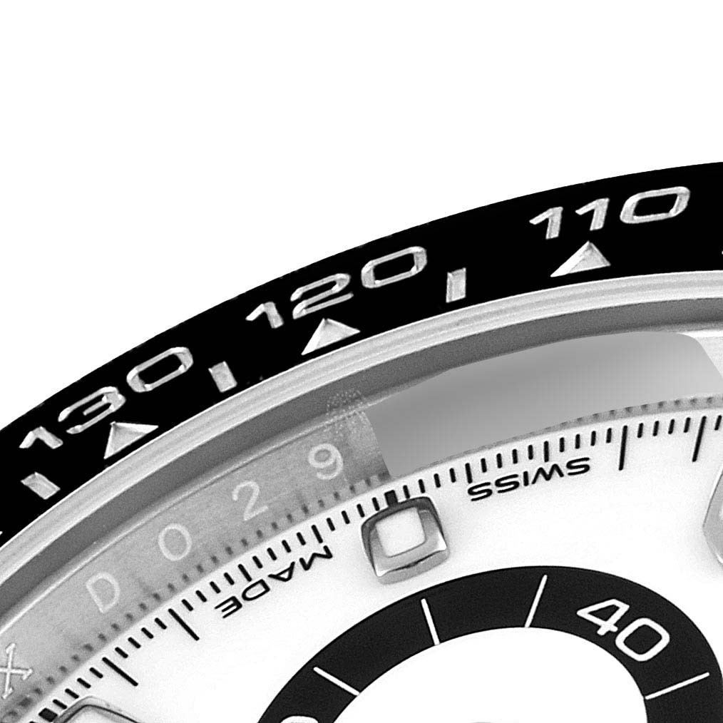 The image shows a close-up of the tachymeter scale on the bezel and part of the dial on a Rolex Daytona 116500 Men's Stainless Steel White Dial 116500 Men's Stainless Steel White Dial watch.