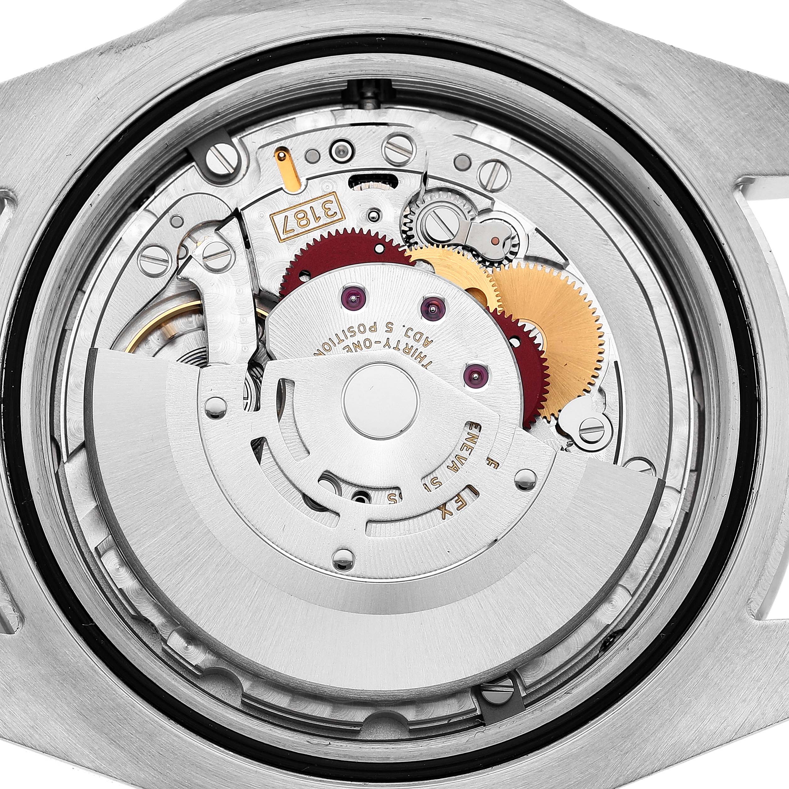 The image shows the movement of a Rolex Explorer 216570 Men's Stainless Steel White Dial watch, viewed from the back, highlighting gears and components.