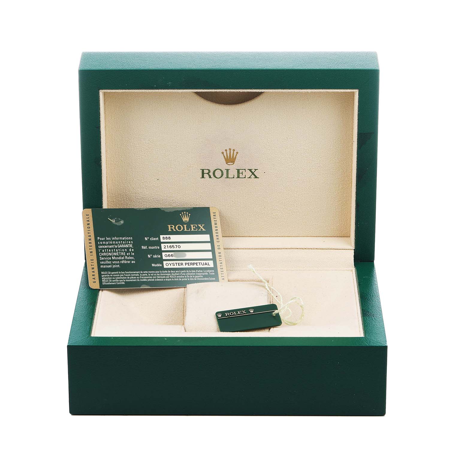 The image shows a Rolex Explorer 216570 Men's Stainless Steel White Dial watch box with a certification card and a tag inside.