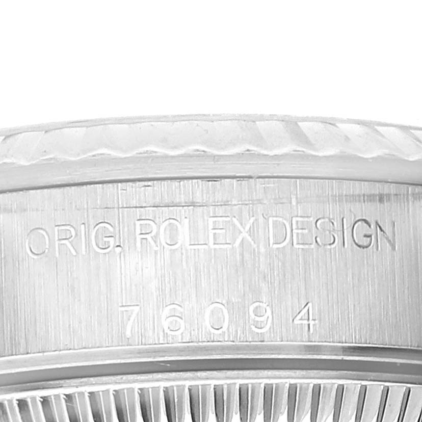 This image shows a close-up of the engraving on the bezel and side of a Rolex Oyster Perpetual 76094 Women
s Stainless Steel Silver Dial 76094 Women
s Stainless Steel Silver Dial model watch.