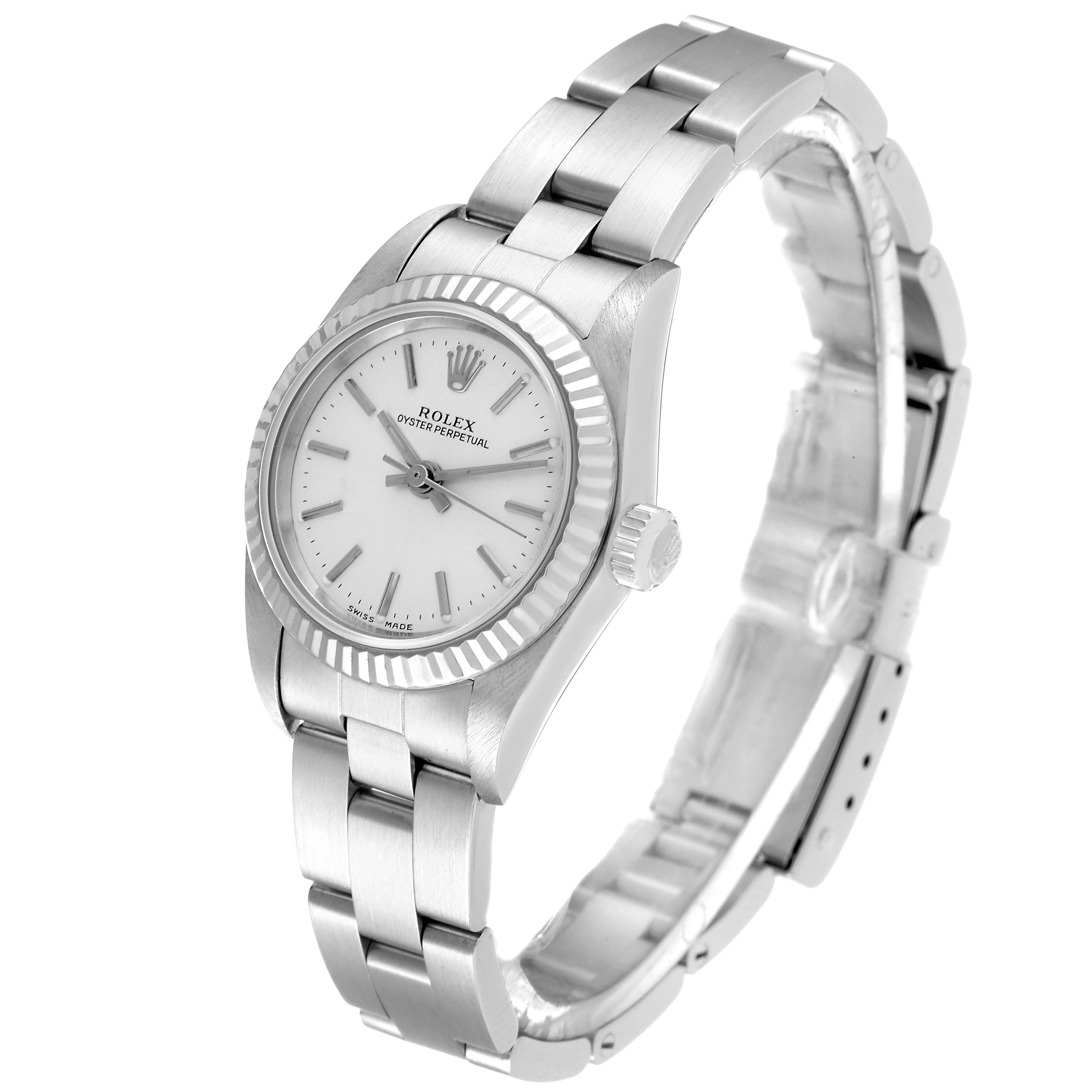 The Rolex Oyster Perpetual 76094 Women
s Stainless Steel Silver Dial 76094 Women
s Stainless Steel Silver Dial watch is angled to show the face, bezel, crown, and stainless steel bracelet.