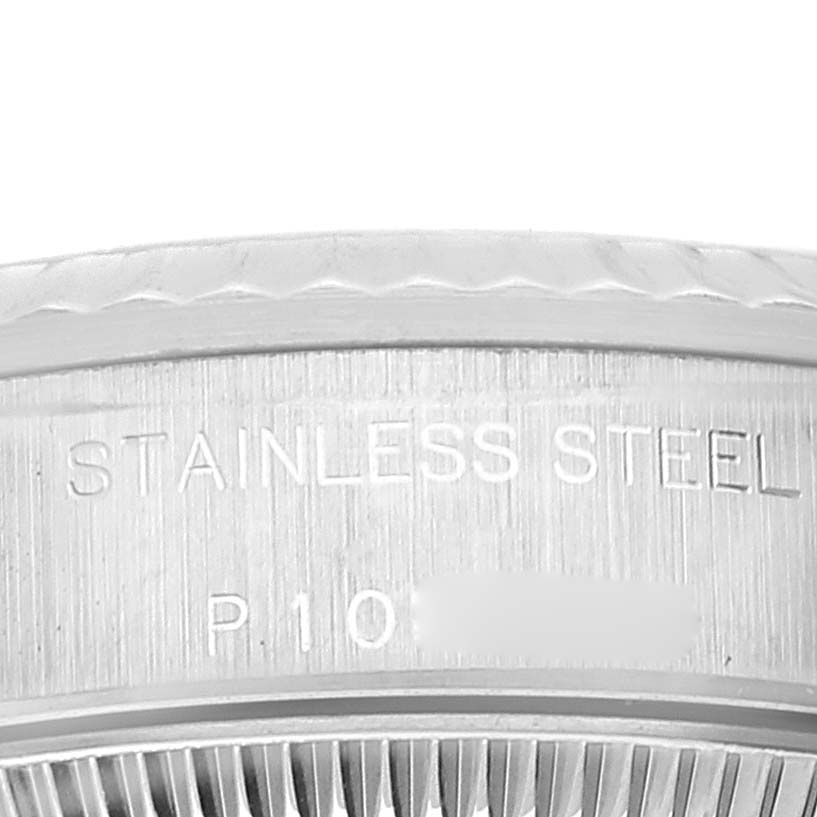 The image shows a close-up of the stainless steel bezel with engraved text on a Rolex Oyster Perpetual 76094 Women
s Stainless Steel Silver Dial 76094 Women
s Stainless Steel Silver Dial watch.