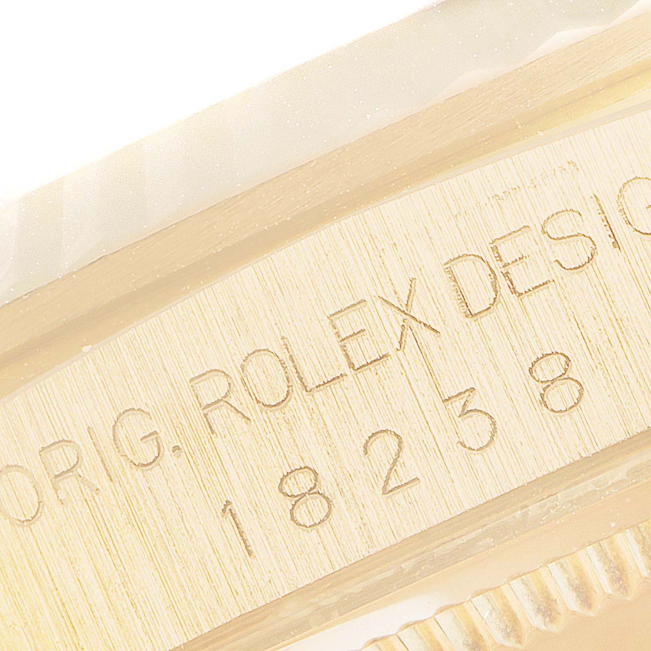 The image shows a close-up of the case side and bezel edge of a Rolex President 18238 Men's Yellow Gold Champagne Dial 18238 Men's Yellow Gold Champagne Dial model, featuring engraved model details.
