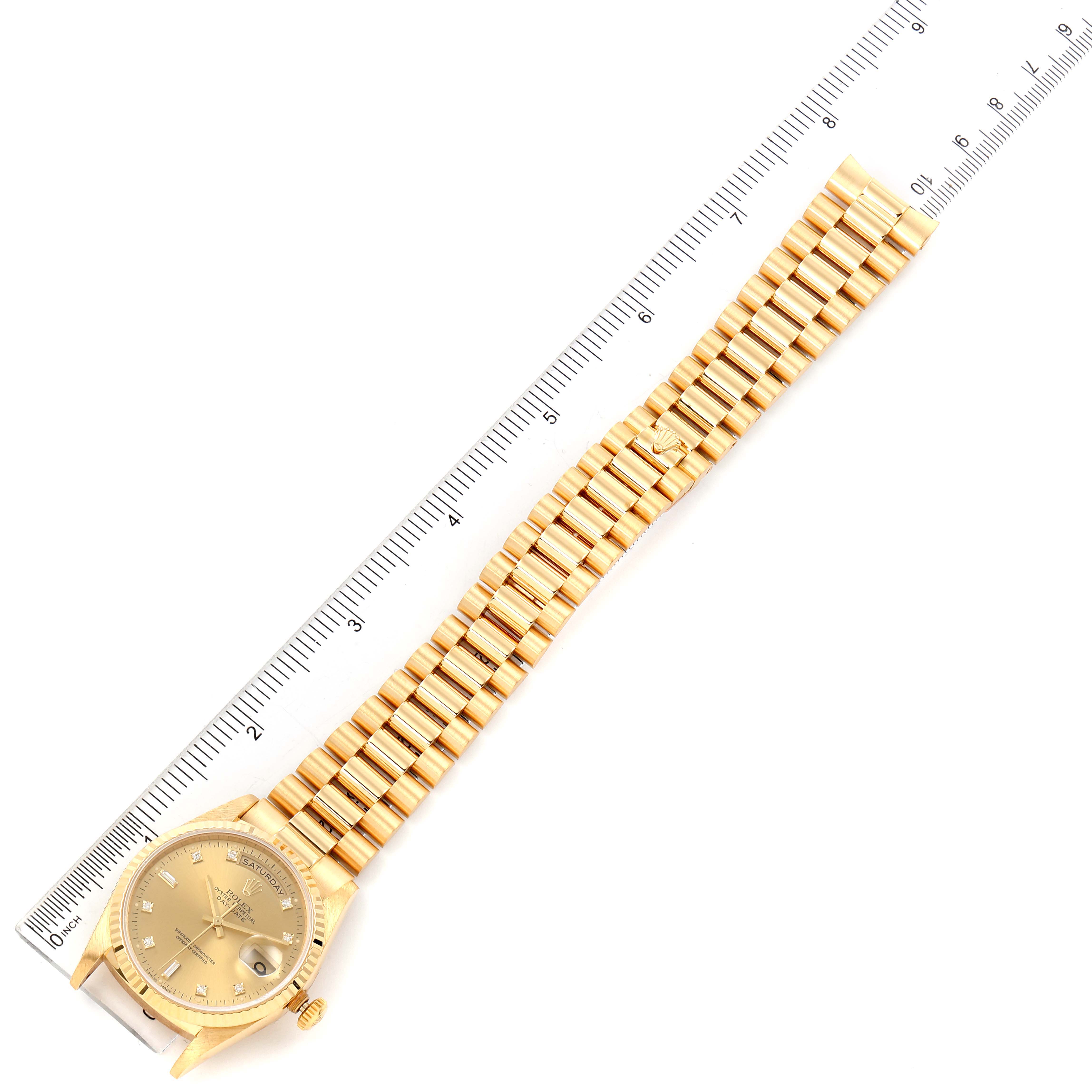 The image shows a Rolex President 18238 Men's Yellow Gold Champagne Dial 18238 Men's Yellow Gold Champagne Dial watch laid flat with its face and bracelet alongside a ruler for scale.