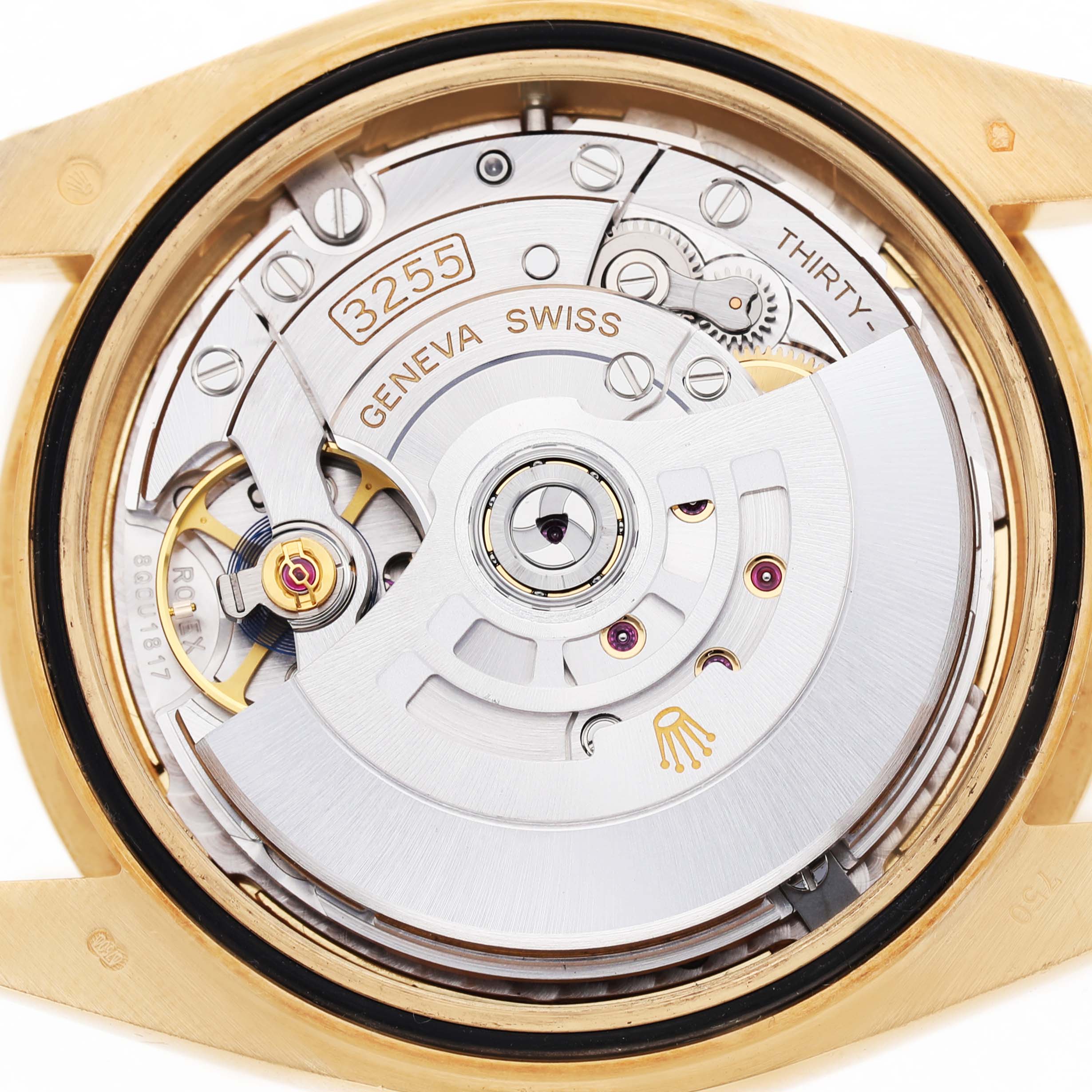 The image shows the movement of a Rolex President 228238 Men's Yellow Gold Champagne Dial model watch, viewed from the back with gears and the rotor visible.