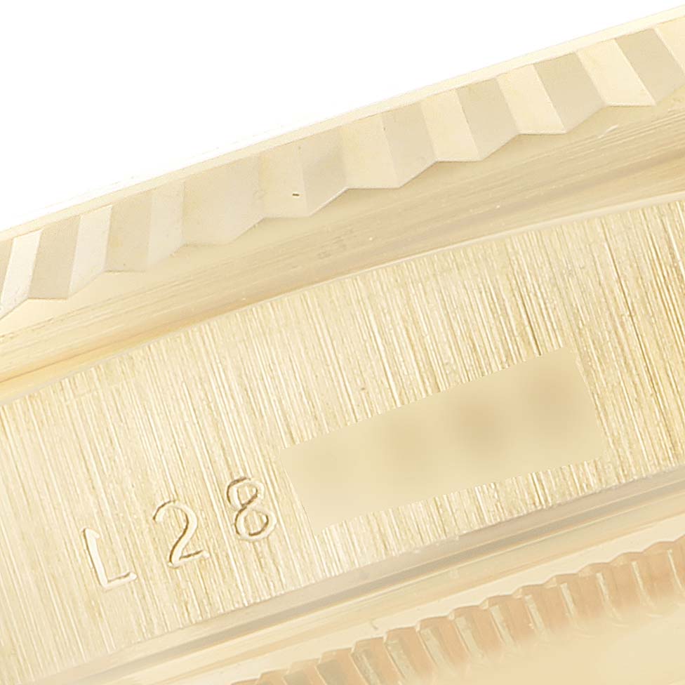 The image shows a close-up angle of the fluted bezel and engraved details on the case of a Rolex President 18238 Men
s Yellow Gold Champagne Dial 18238 Men
s Yellow Gold Champagne Dial model watch.