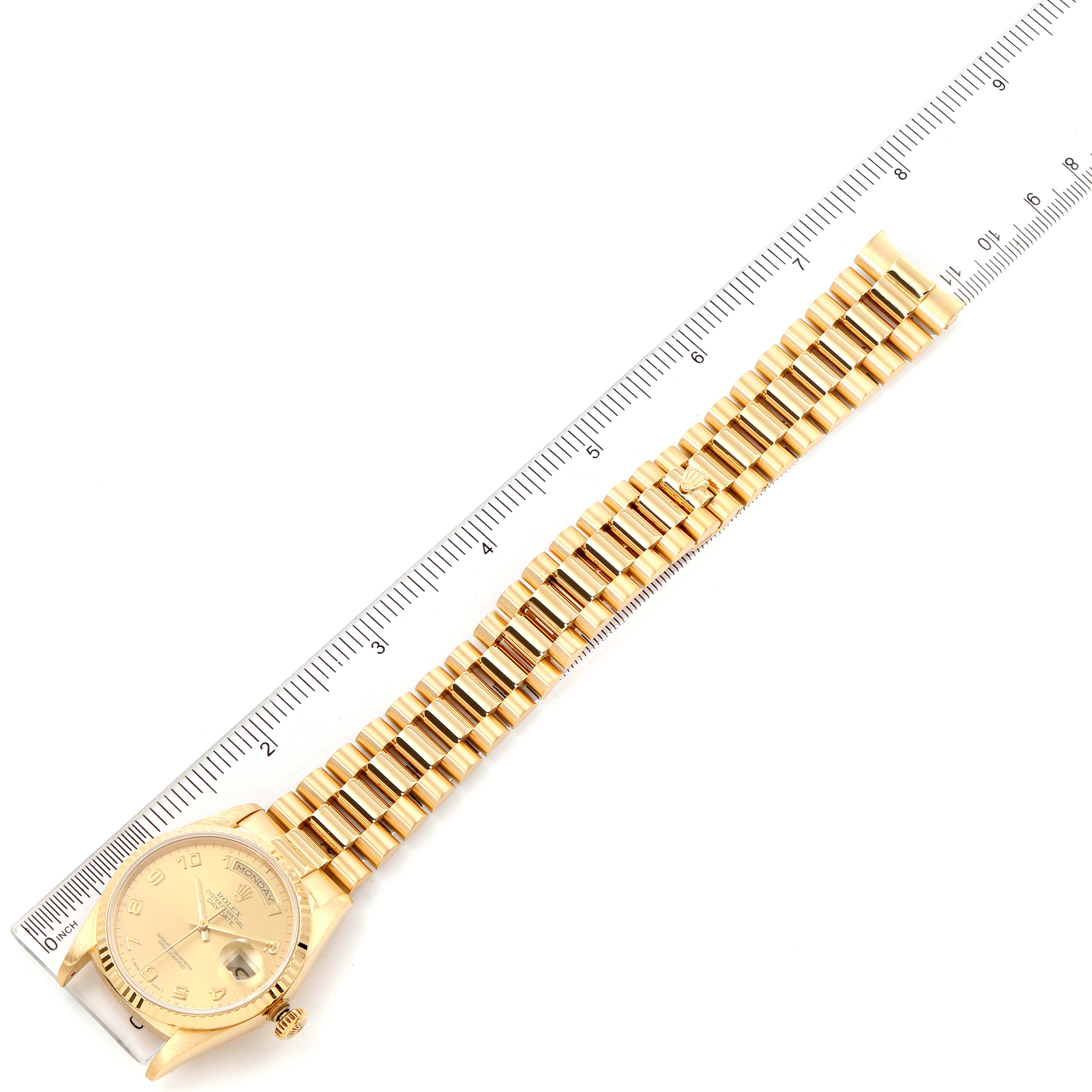 This image shows a top-down view of a Rolex President 18238 Men
s Yellow Gold Champagne Dial 18238 Men
s Yellow Gold Champagne Dial watch, including the face, bezel, crown, and full bracelet, aligned with a ruler.