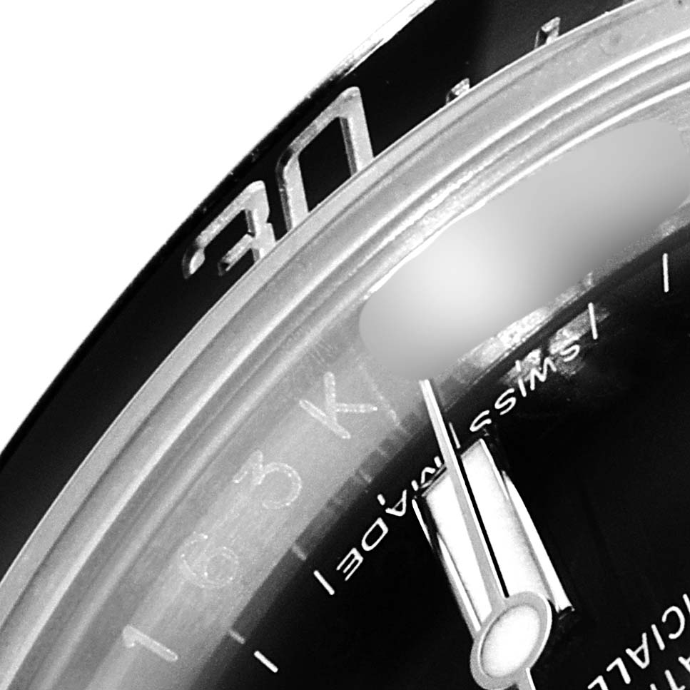 The image shows a close-up of the bezel, minute hand, and part of the dial of a Rolex Sea-Dweller 116600 Men's Stainless Steel Black Dial 116600 Men's Stainless Steel Black Dial watch.