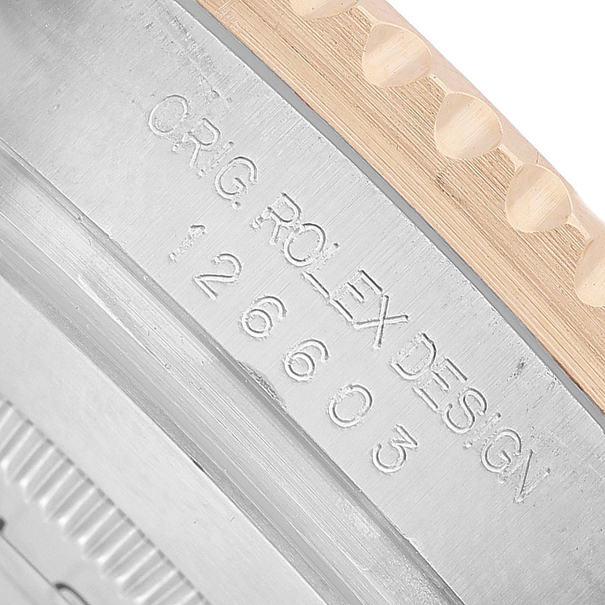 The image shows a close-up of the Rolex Sea-Dweller 126603 Men's Steel and Gold (two tone) Black Dial's case side engraving, highlighting its model number.