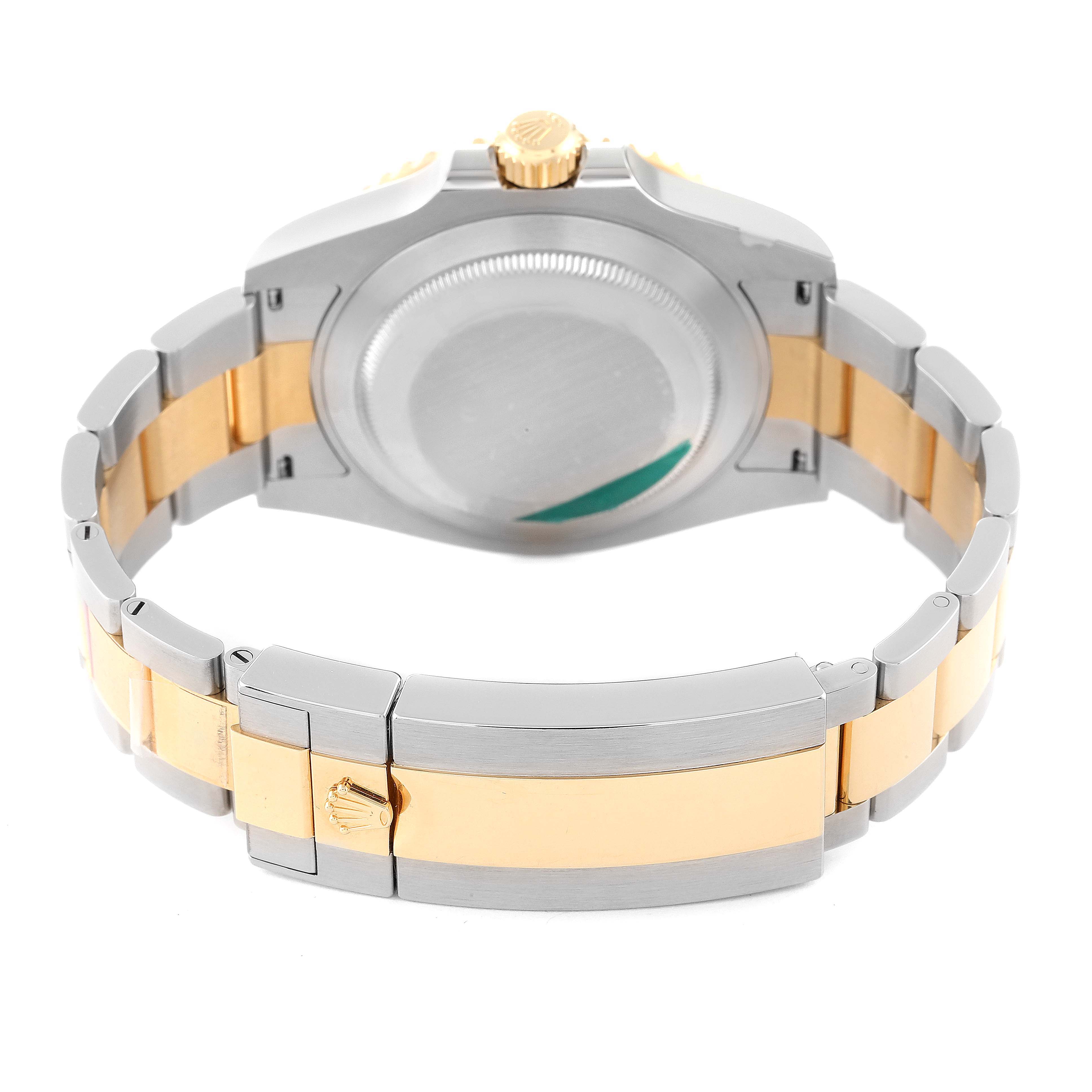 The image shows the back view of a Rolex Submariner 126613 Men's Steel and Gold (two tone) Black Dial 126613 Men's Steel and Gold (two tone) Black Dial watch, highlighting its two-tone bracelet and closed clasp.