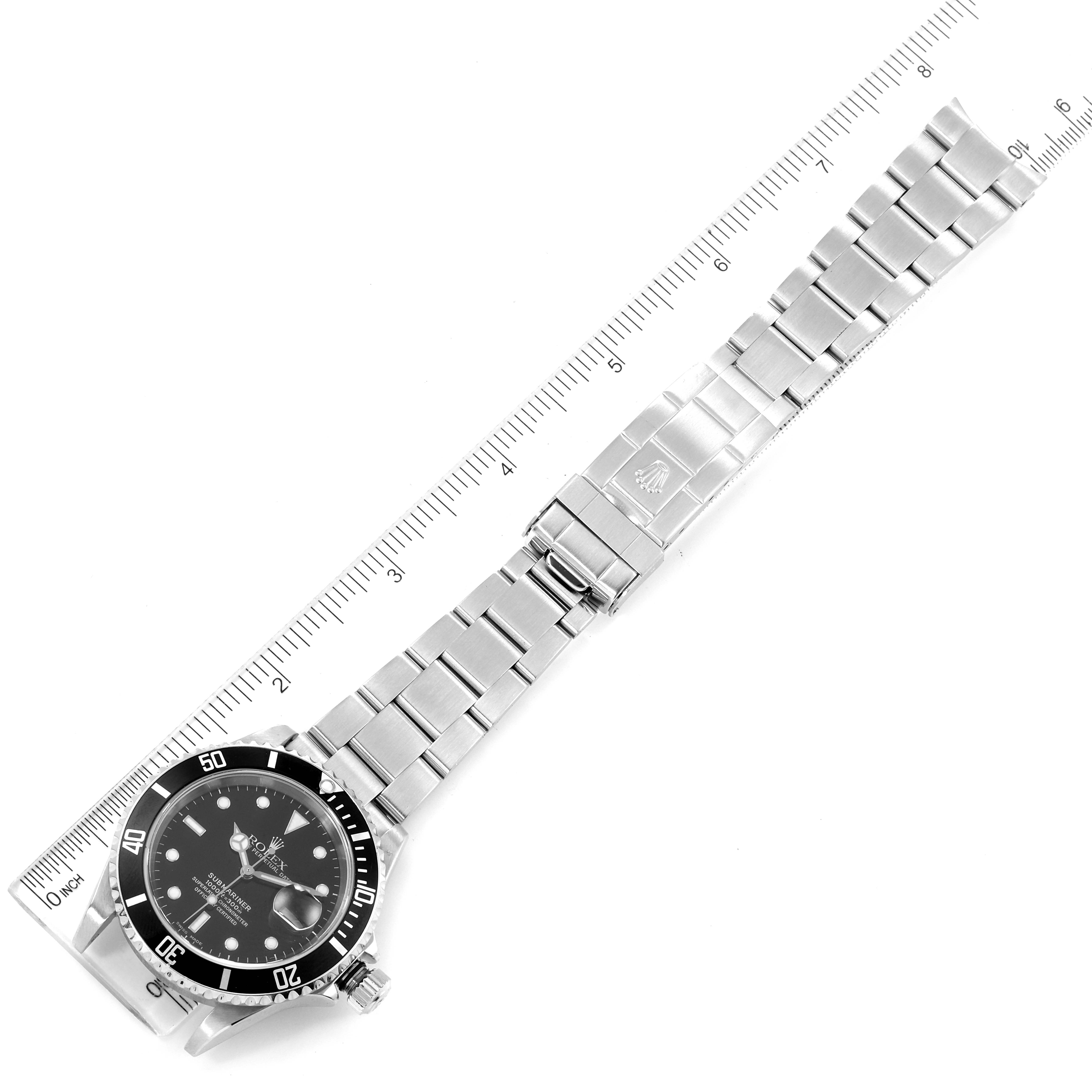 The image shows the full length of a Rolex Submariner 16610 Men
s Stainless Steel Black Dial 16610 Men
s Stainless Steel Black Dial watch, laid flat against a ruler for measurement.