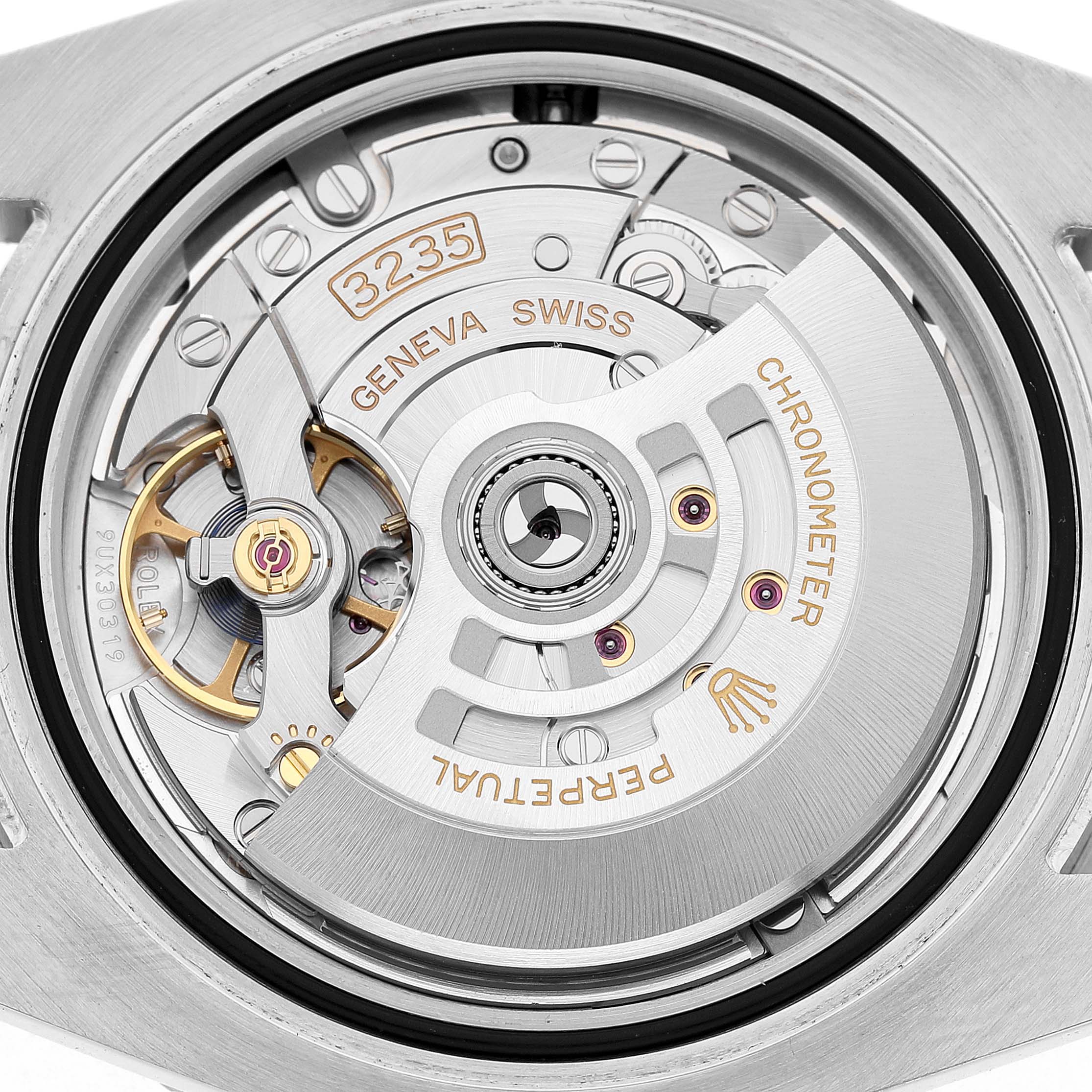 This image shows the movement of a Rolex Submariner 126610 Men's Stainless Steel Black Dial, showcasing its intricate gears and rotor from a top view.