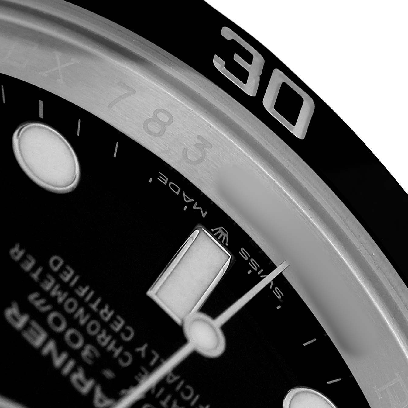 The image shows a close-up of the Rolex Submariner 126610 Men's Stainless Steel Black Dial's partial bezel, dial, and indices from an angled top-down view.