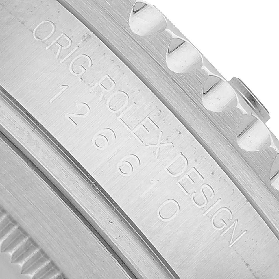 The image shows a close-up of the side of a Rolex Submariner 126610 Men's Stainless Steel Black Dial, highlighting the engraved model number and bezel edge.