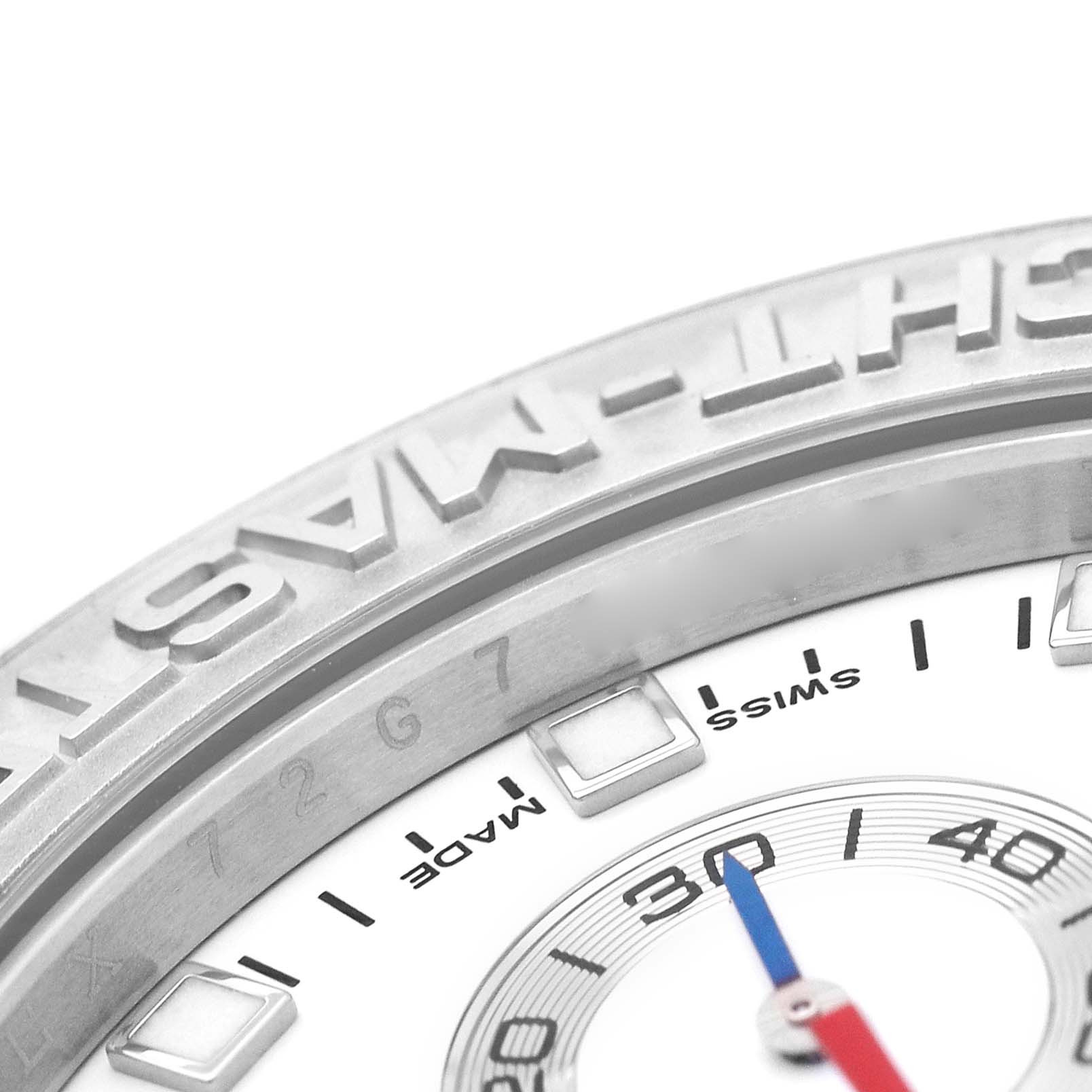 The image shows a close-up of the Rolex Yacht-Master 116689 Men's White Gold White Dial's bezel and part of the dial, emphasizing the engravings and markers.