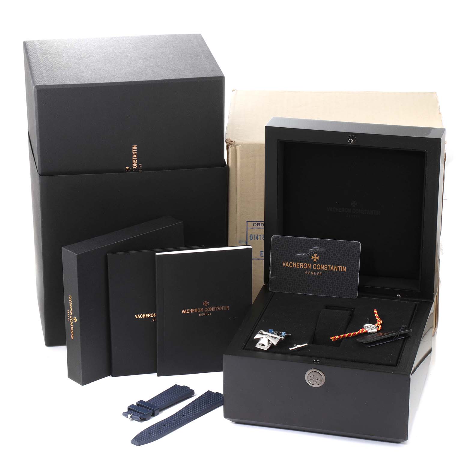 The image shows the packaging, warranty card, user manuals, and straps for the Vacheron Constantin Overseas 7900V/110A-B334 Men's Stainless Steel Blue Dial 7900V/110A-B334 Men's Stainless Steel Blue Dial watch.