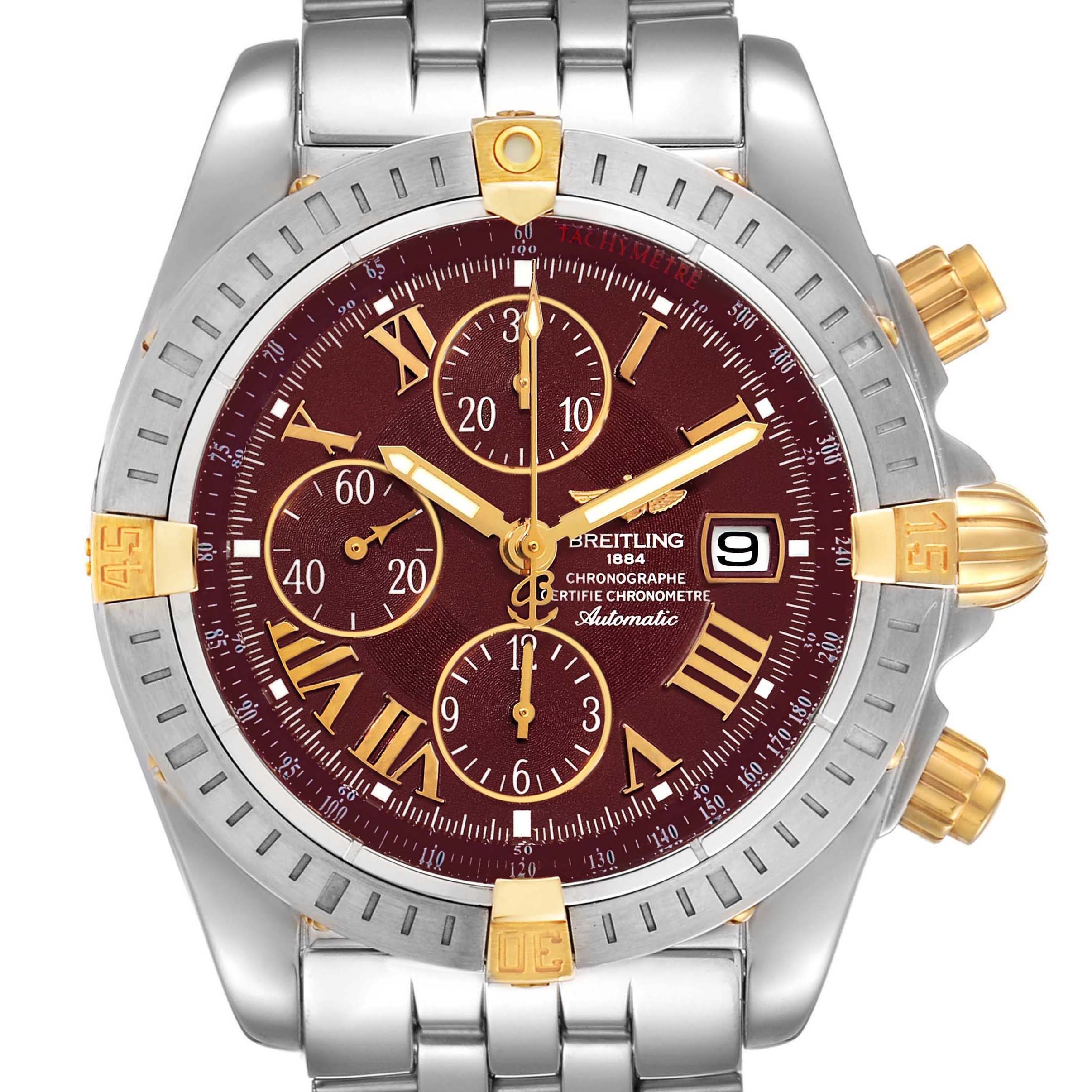 The image shows a front view of a Breitling Chronomat B13356 Men's Steel and Gold (two tone) Burgundy Dial B13356 Men's Steel and Gold (two tone) Burgundy Dial watch, featuring a maroon dial, gold accents, and a metal bracelet.