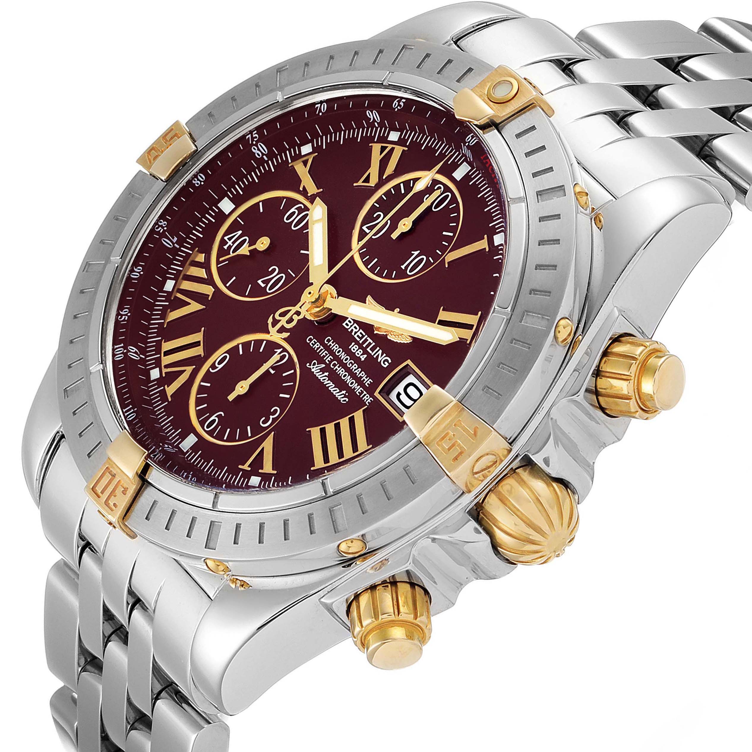 The Breitling Chronomat B13356 Men's Steel and Gold (two tone) Burgundy Dial B13356 Men's Steel and Gold (two tone) Burgundy Dial watch is shown at an angled close-up, highlighting the dial, crown, pushers, and bracelet.