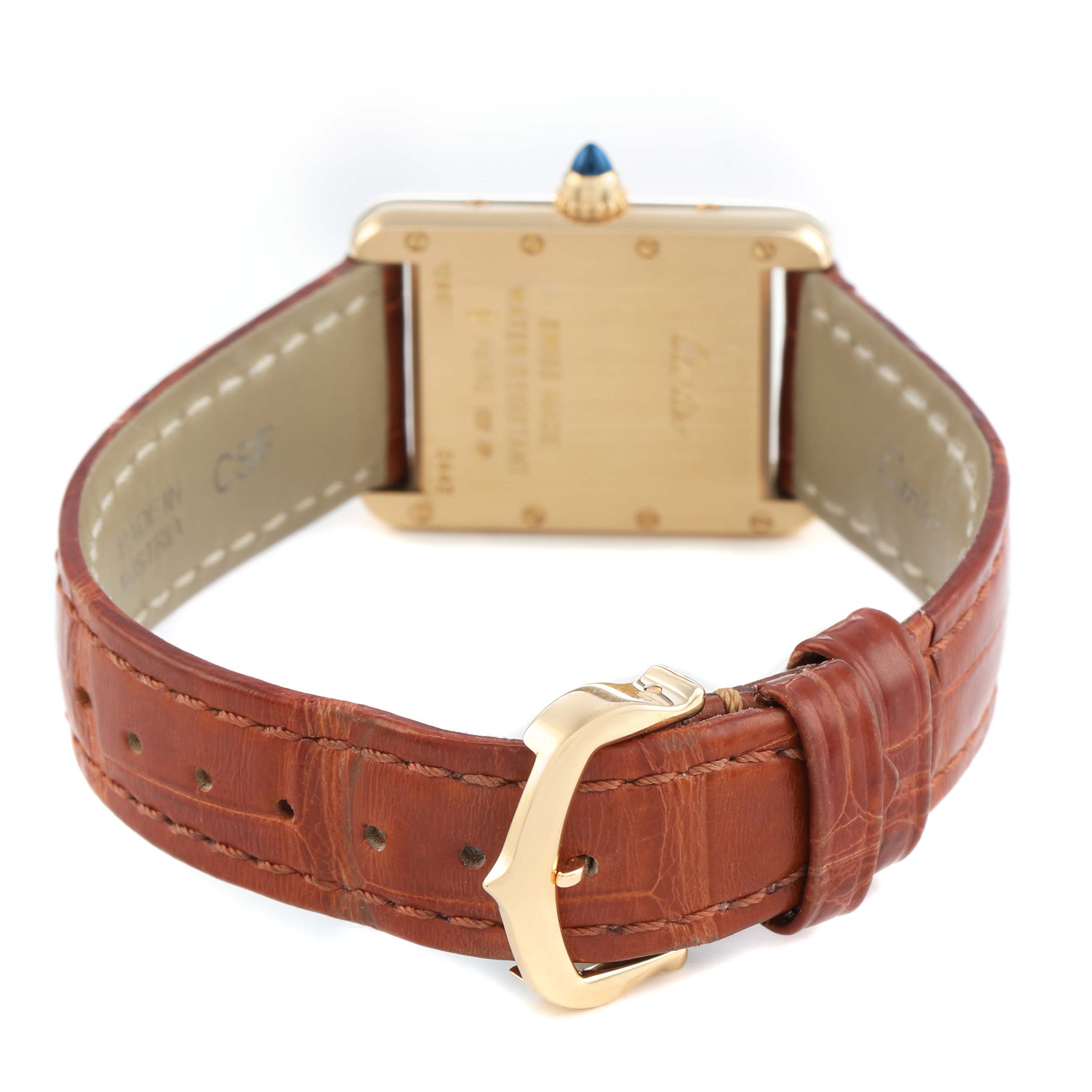 The image shows the back of a Cartier Tank Louis W1529856 Women's Yellow Gold Silver Dial watch and its brown leather strap with a gold buckle.