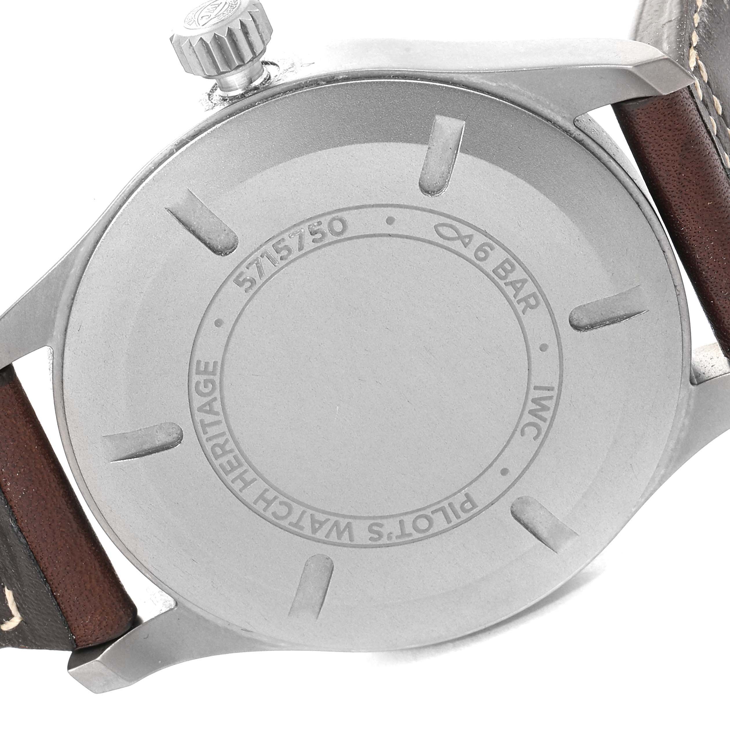 The image shows the back case of the IWC Pilot IW327006 Men's Titanium Black Dial IW327006 Men's Titanium Black Dial model watch, including the crown and part of the leather strap.