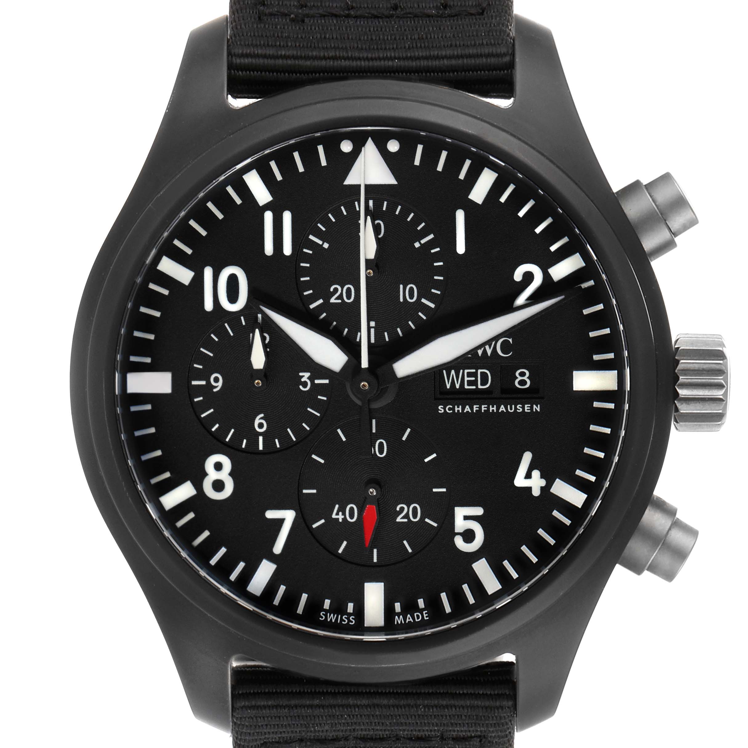 The image shows a frontal view of the Pilot model by IWC, displaying its black dial, chronograph subdials, pushers, and crown.