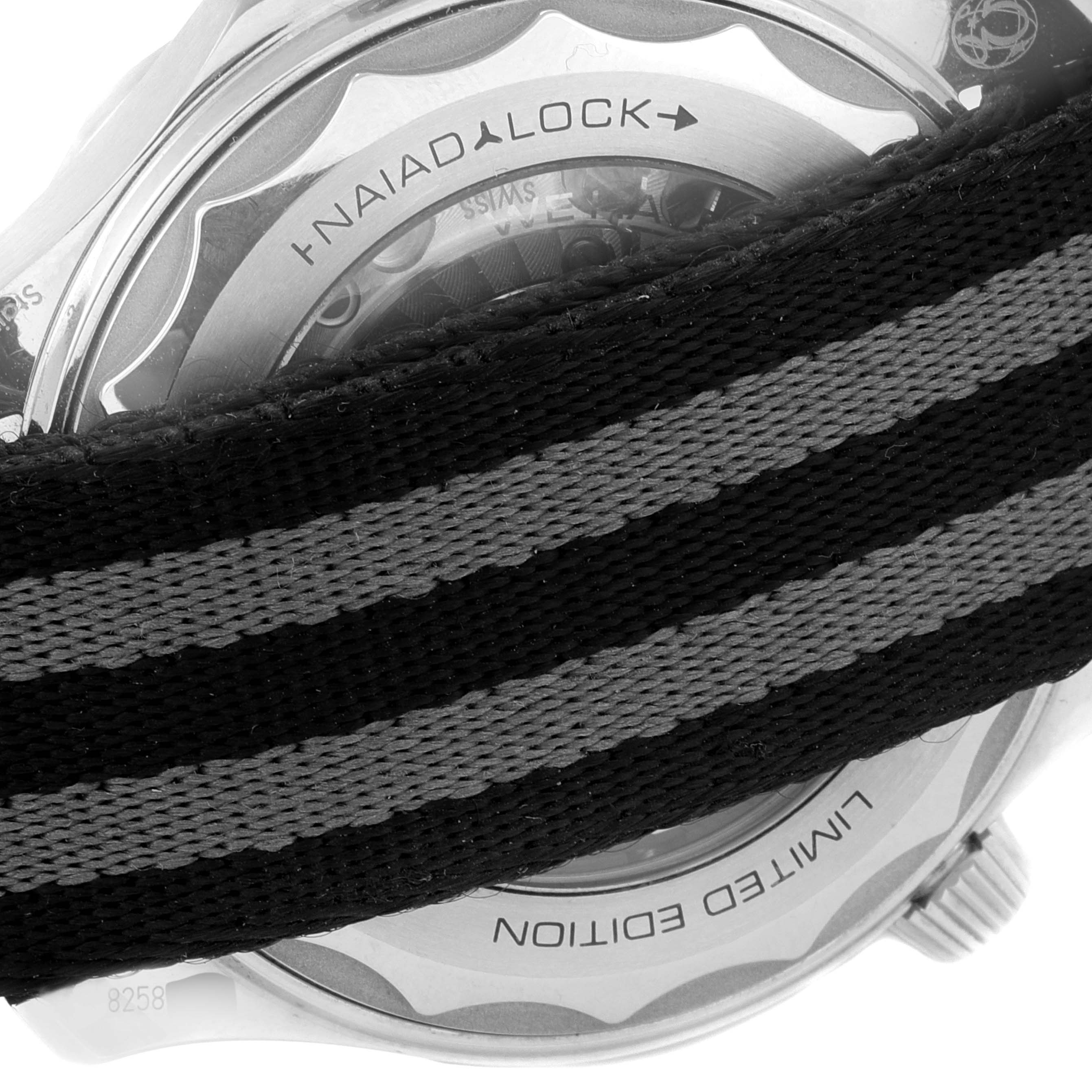 The image shows the back of an Omega Seamaster 210.22.42.20.01.004 Men's Stainless Steel Black Dial 210.22.42.20.01.004 Men's Stainless Steel Black Dial watch with a view of the 'NAIAD LOCK' system and a striped watch strap partially covering it.