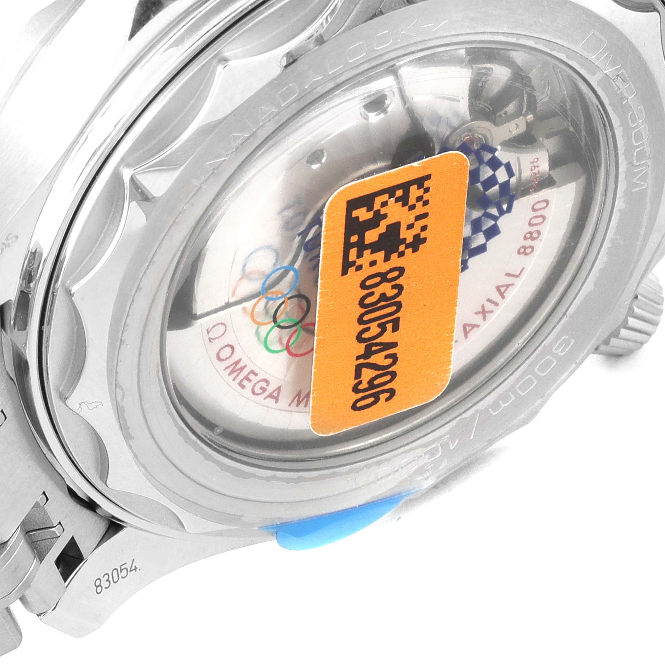 The image shows the rear case of a Seamaster model by Omega, highlighting the transparent case back and serial number.