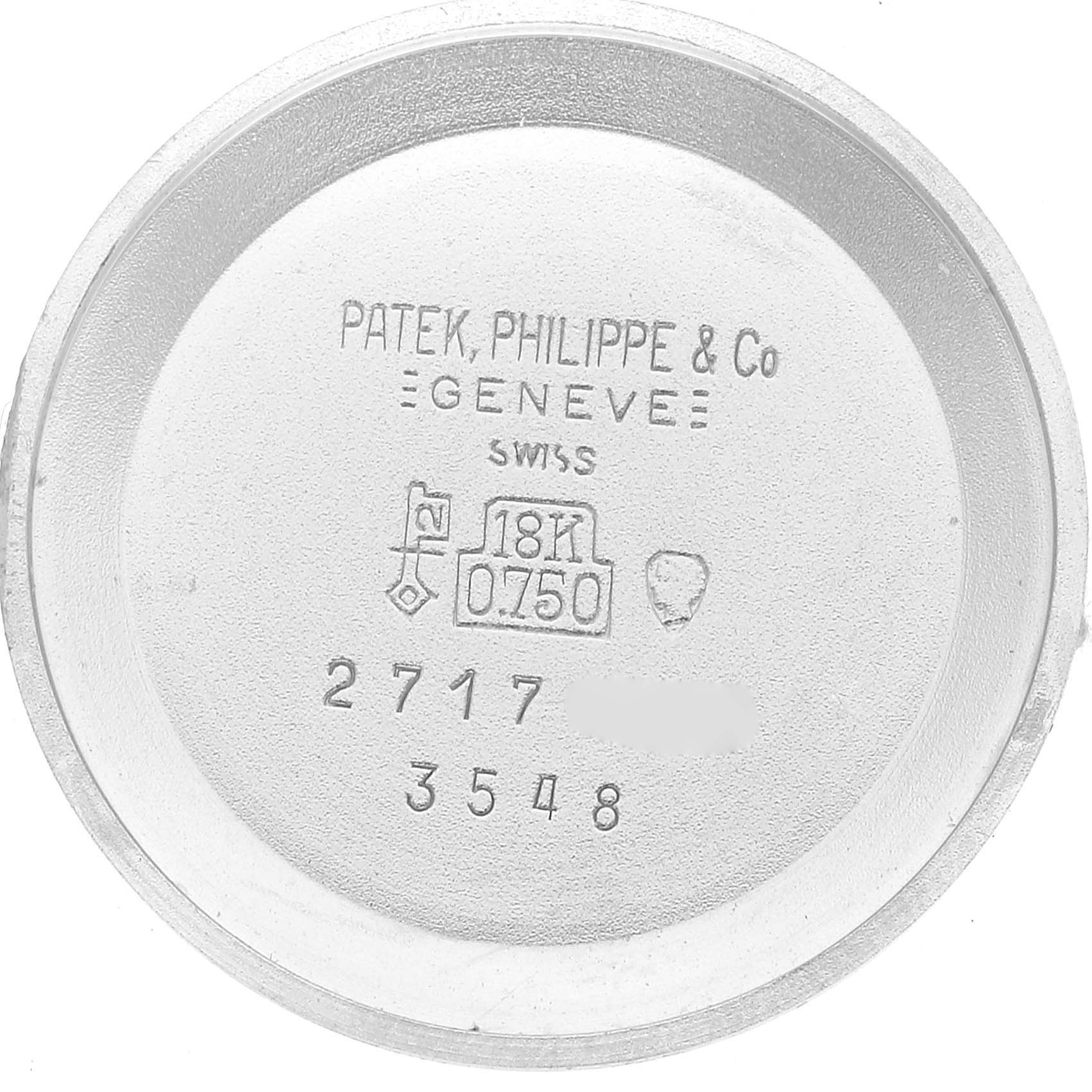 This image shows the inside case back of a Patek Philippe Golden Ellipse 3548 Women's White Gold Blue Dial 3548 Women's White Gold Blue Dial watch with inscriptions and hallmarks.
