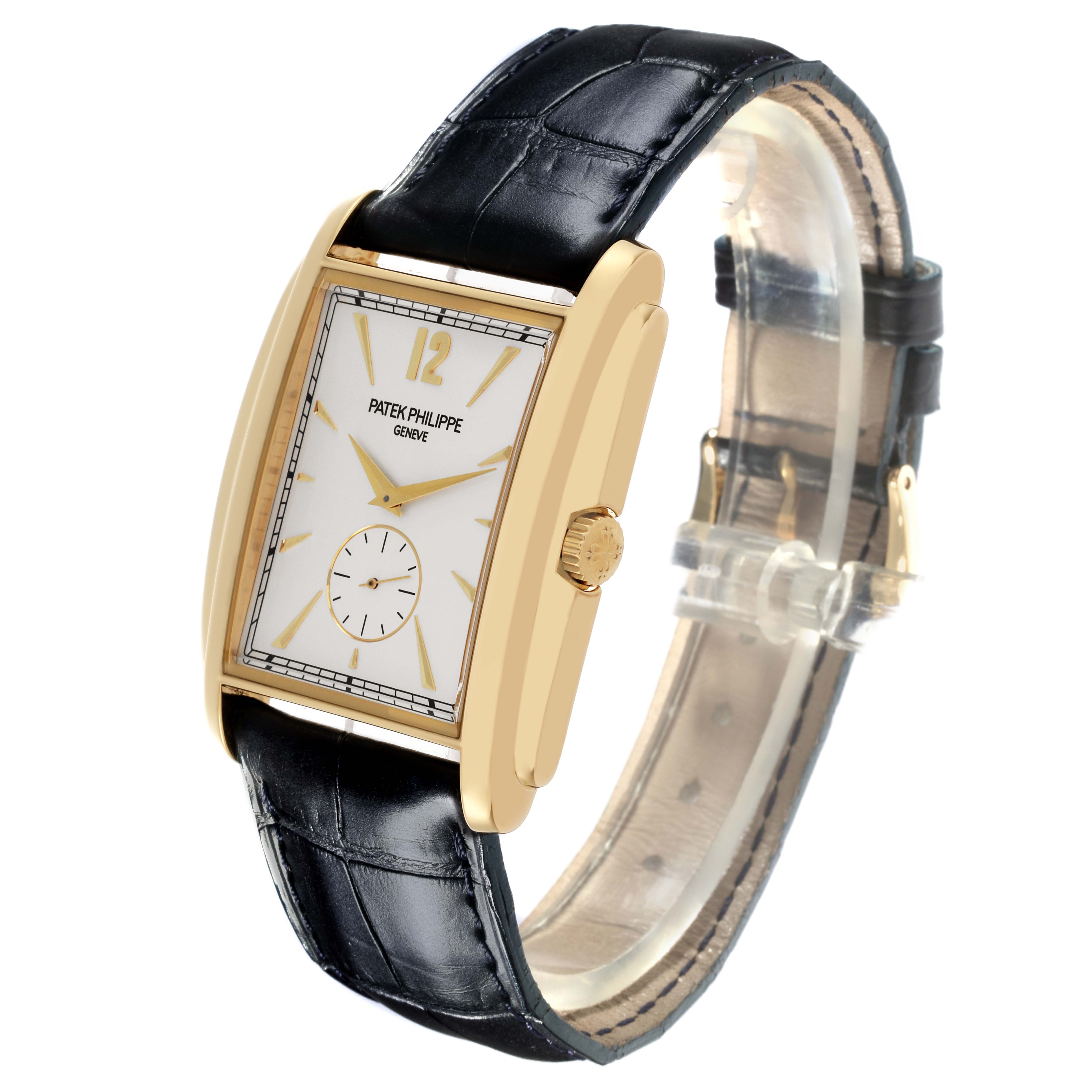 The Patek Philippe Gondolo 5124J Men's Yellow Gold Silver Dial 5124J Men's Yellow Gold Silver Dial watch is shown at a three-quarter angle, highlighting its rectangular gold case, white dial, and black leather strap.
