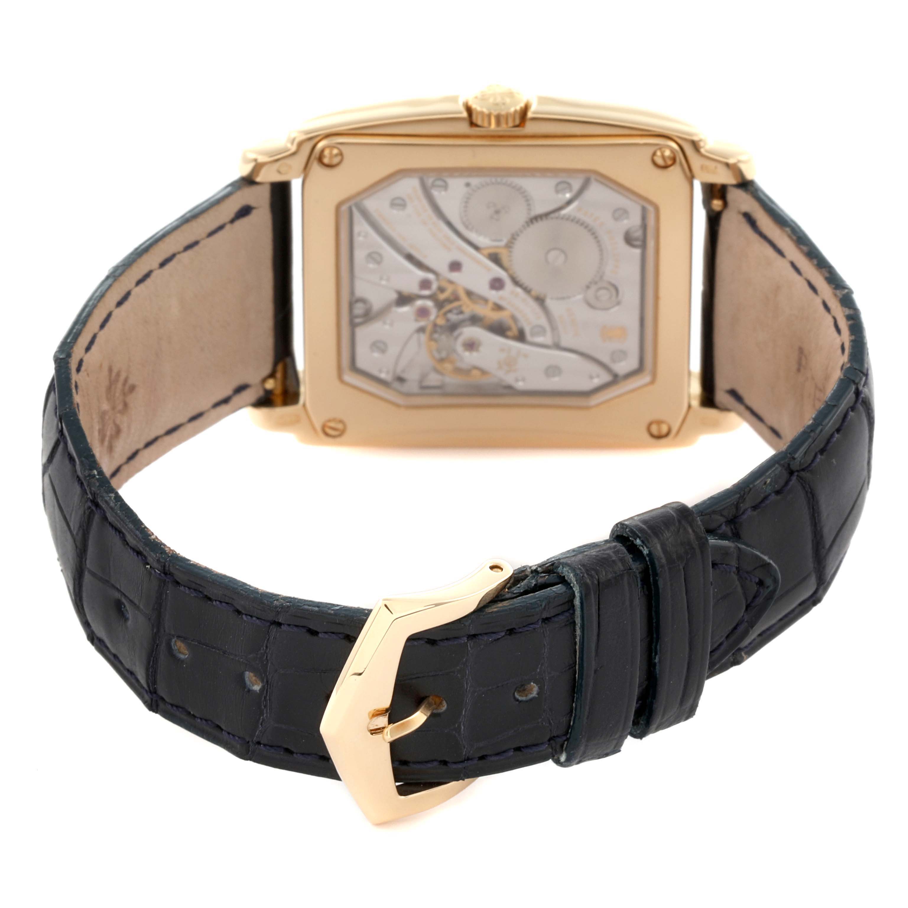 The image shows the back view of the Patek Philippe Gondolo 5124J Men's Yellow Gold Silver Dial 5124J Men's Yellow Gold Silver Dial, highlighting its intricate movement and the leather strap with a gold buckle.