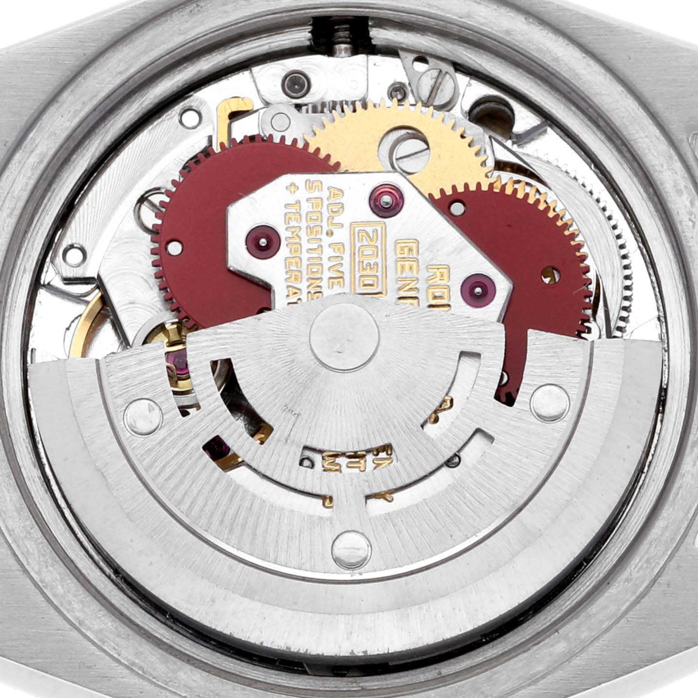 The image shows the movement of a Rolex Date 6924 Women's Stainless Steel Silver Dial 6924 Women's Stainless Steel Silver Dial watch from a top-down angle, highlighting gears and the rotor mechanism.