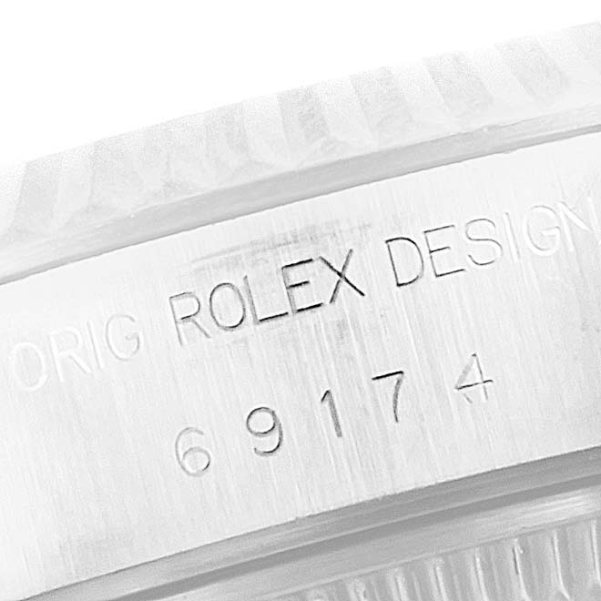 This image shows a close-up angle of the serial number and "Rolex Design" engraving on the side of a Rolex Datejust 69174 Women
s Stainless Steel Silver Dial 69174 Women
s Stainless Steel Silver Dial watch.