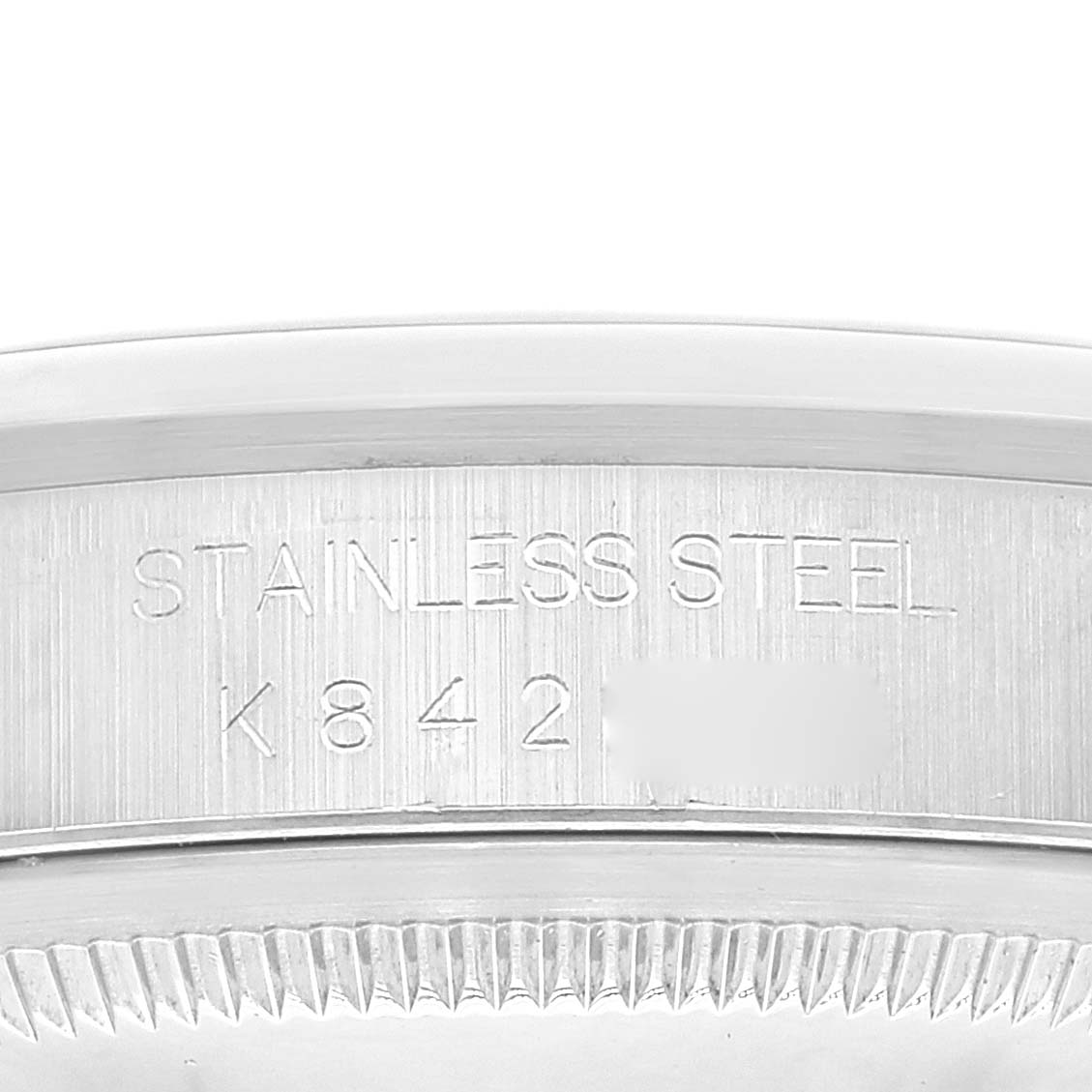 This image shows a close-up angle of the stainless steel case back engraving on a Rolex Datejust 16200 Men's Stainless Steel Blue Dial 16200 Men's Stainless Steel Blue Dial watch.