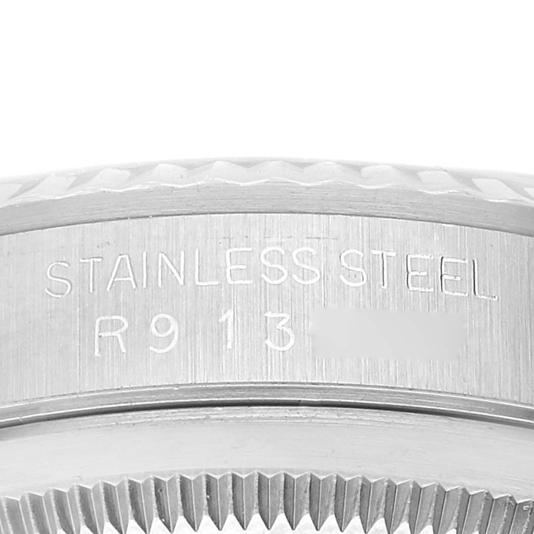 This image shows a close-up view of the stainless steel casing with engraved serial numbers for a Rolex Datejust 16234 Men's Stainless Steel Silver Dial 16234 Men's Stainless Steel Silver Dial watch.