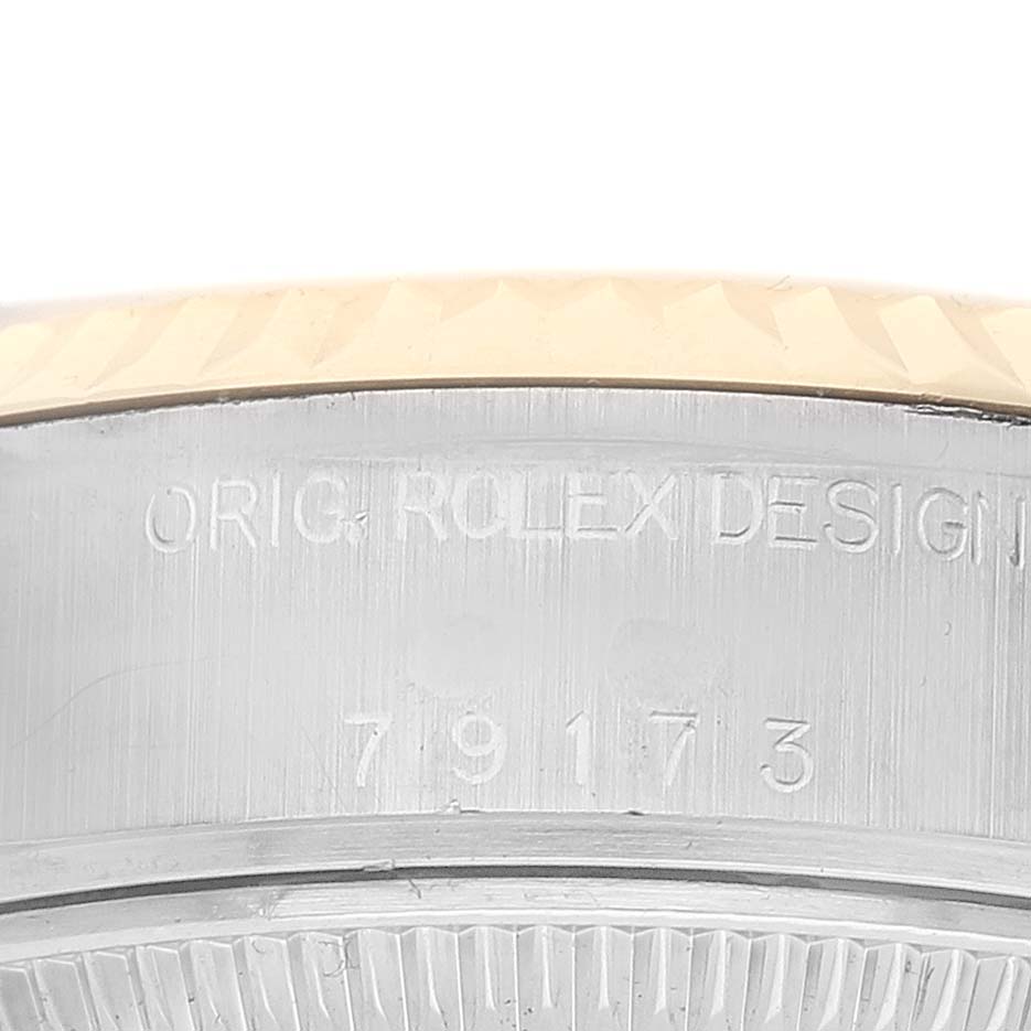 This image shows the side engraving of a Rolex Datejust 79173 Women's Stainless Steel Champagne Dial watch, displaying the model details and design engravings.