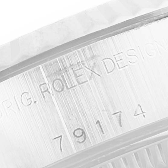 This image shows a close-up of the serial number and engravings on the case side of a Rolex Datejust 79174 Women's Stainless Steel Mother of Pearl Dial 79174 Women's Stainless Steel Mother of Pearl Dial watch.
