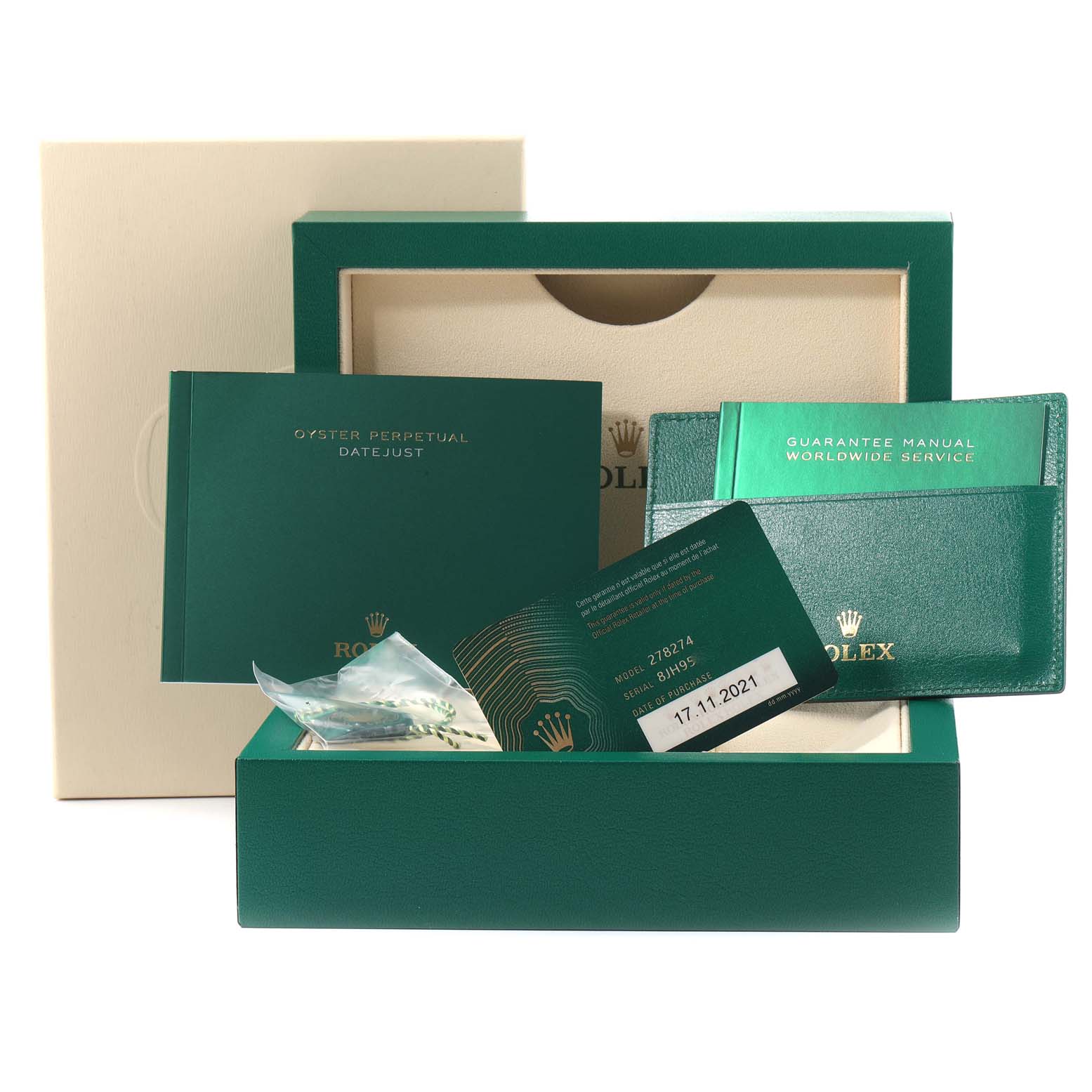The image shows the accessories for a mid-size Rolex Datejust, including manuals, a warranty card, and the watch's box.