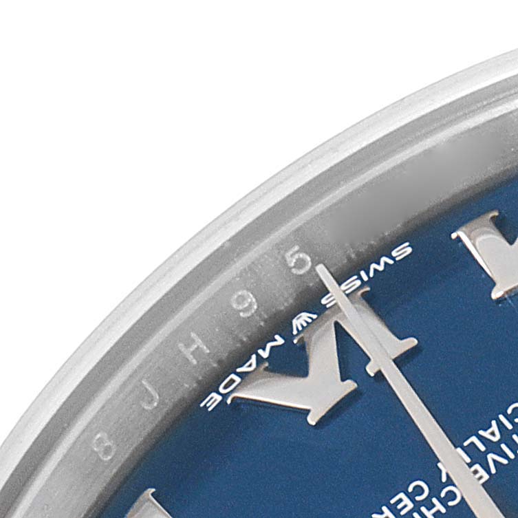 This image shows the upper left part of the dial and bezel of a Rolex Mid-Size 278274 Women's Stainless Steel Blue Dial 278274 Women's Stainless Steel Blue Dial watch, featuring hour markers and the "Swiss Made" text.