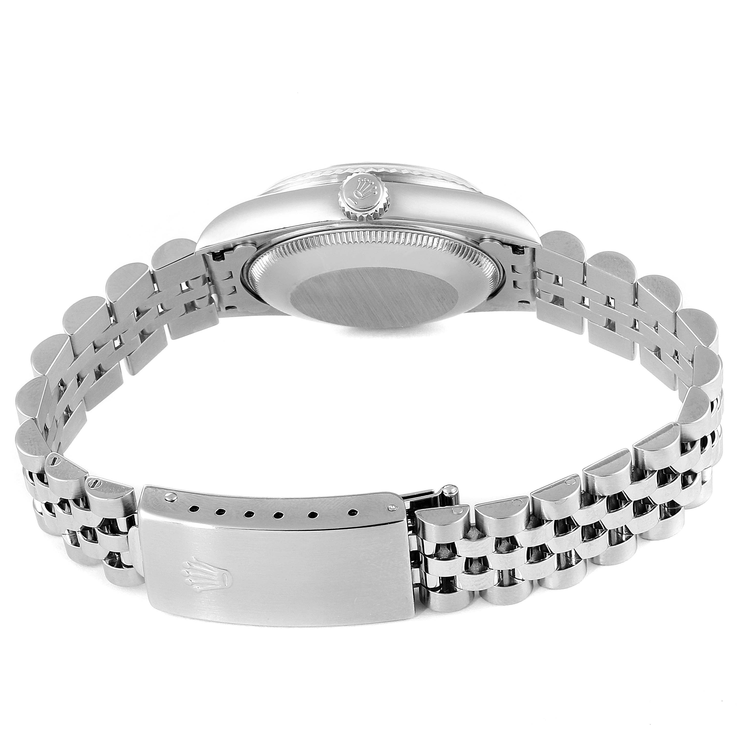 The image shows the back of a Mid-Size Rolex watch, highlighting the case back, crown, and part of the bracelet with the clasp.