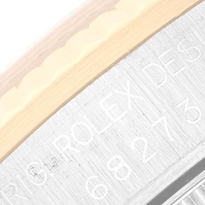 The image shows a close-up of the bezel and engraved text on the inner ring of a Mid-Size Rolex watch.