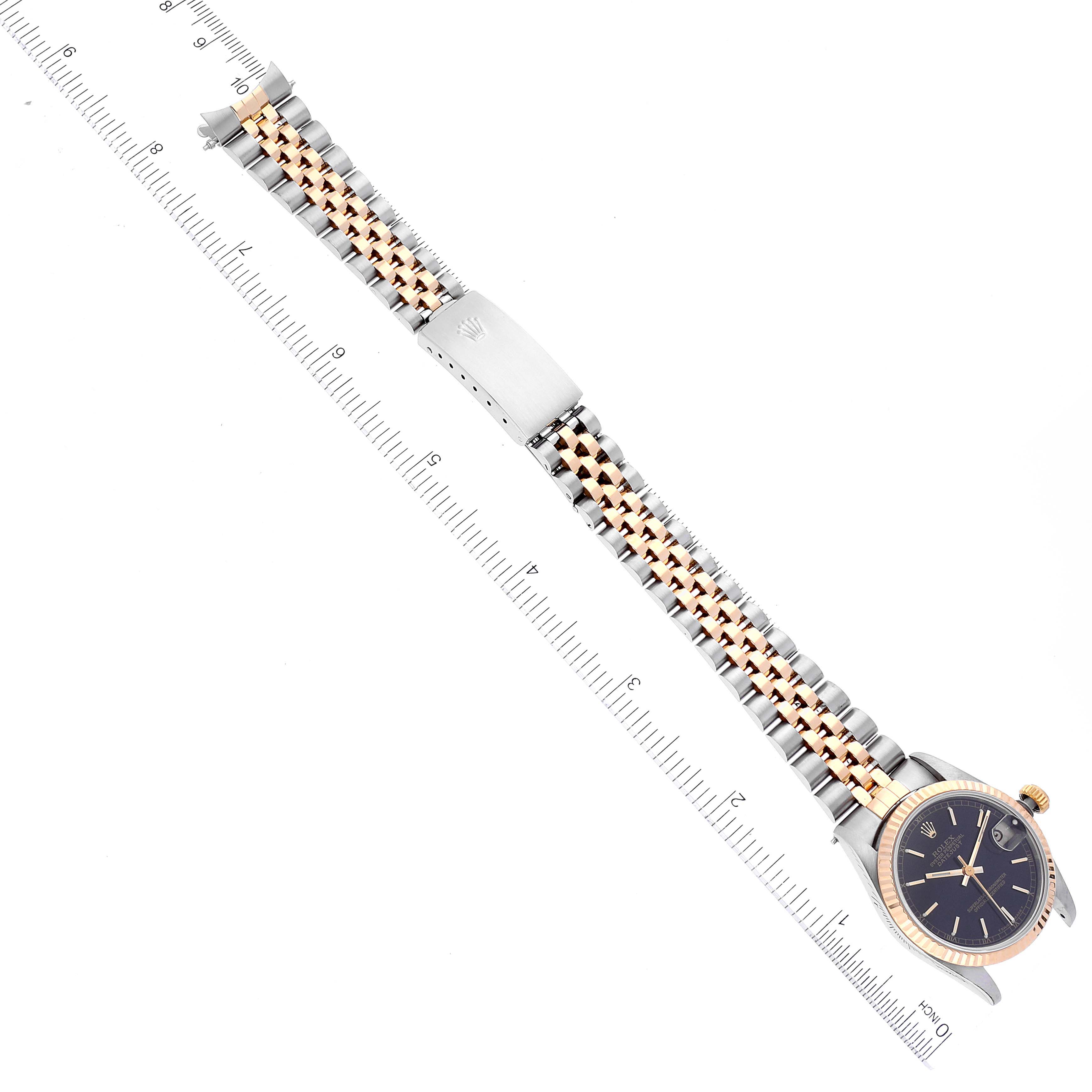 The image shows a full view of a Mid-Size Rolex watch, highlighting its two-tone bracelet, clasp, and face with accompanying rulers.