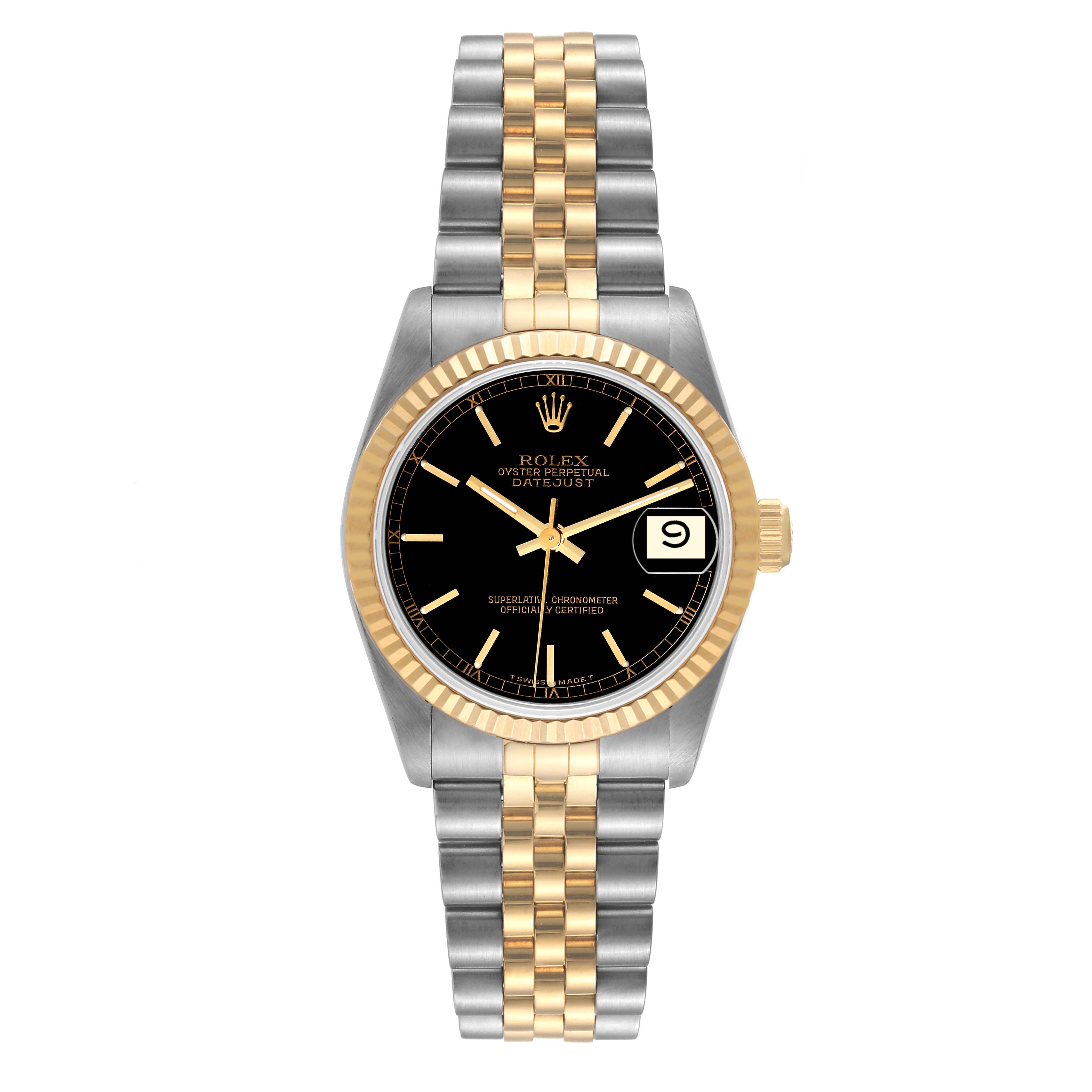 The image shows a front view of a Rolex Oyster Perpetual Datejust Mid-Size watch featuring a black dial, gold bezel, and a two-tone bracelet.