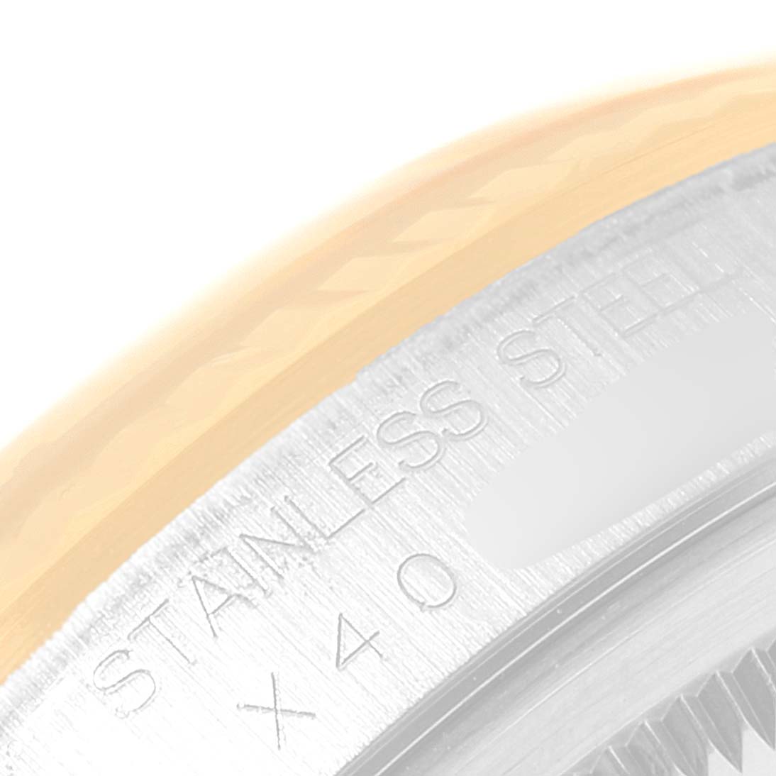 This close-up image of the Rolex Datejust 16233 Men's Steel and Gold (two tone) Champagne Dial 16233 Men's Steel and Gold (two tone) Champagne Dial watch shows the stainless steel case and part of the fluted bezel.