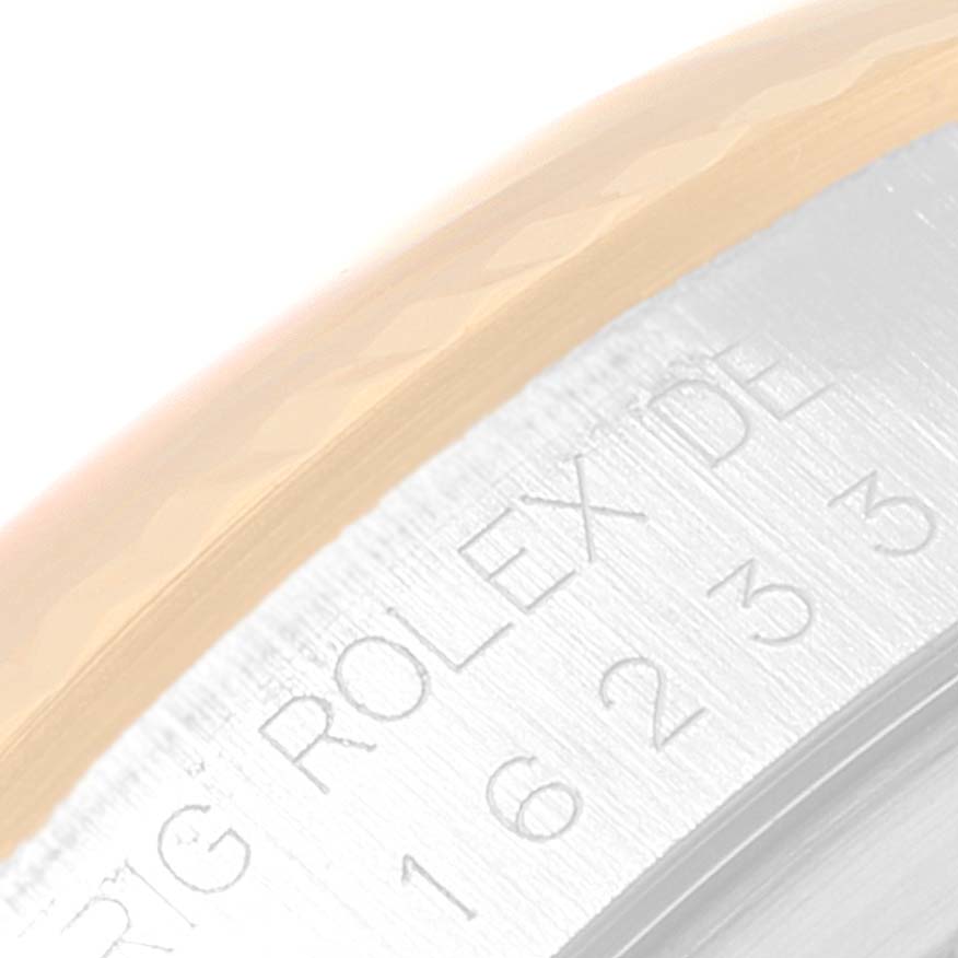 This image shows a close-up of the edge of the bezel and engraved inner case of a Rolex Datejust 16233 Men's Steel and Gold (two tone) Champagne Dial 16233 Men's Steel and Gold (two tone) Champagne Dial.