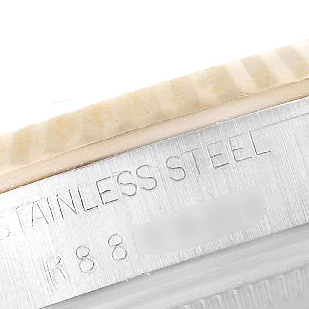 The image shows a close-up of the stainless steel casing of a Rolex Datejust 16233 Men's Steel and Gold (two tone) Champagne Dial 16233 Men's Steel and Gold (two tone) Champagne Dial watch, highlighting the engraved text.