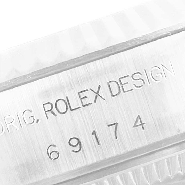 This close-up image shows the engraved serial number and branding on the side of a Rolex Datejust 69174 Women's Stainless Steel Pink Dial 69174 Women's Stainless Steel Pink Dial watch case.