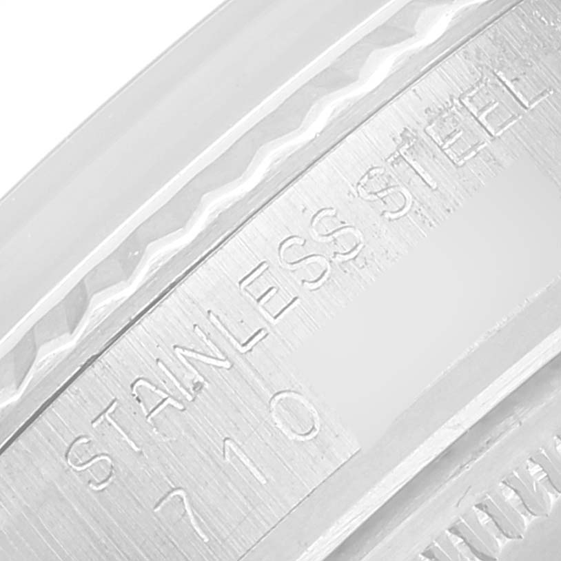 This image shows a close-up of the stainless steel bezel and casing, focusing on the engraved text of the Rolex Vintage Collection 16014 Men
s Stainless Steel Silver Dial 16014 Men
s Stainless Steel Silver Dial model.