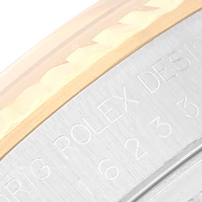 This image shows a close-up of the bezel and engraved inner rim of a Rolex Datejust 16233 Men's Steel and Gold (two tone) Black Dial 16233 Men's Steel and Gold (two tone) Black Dial watch.