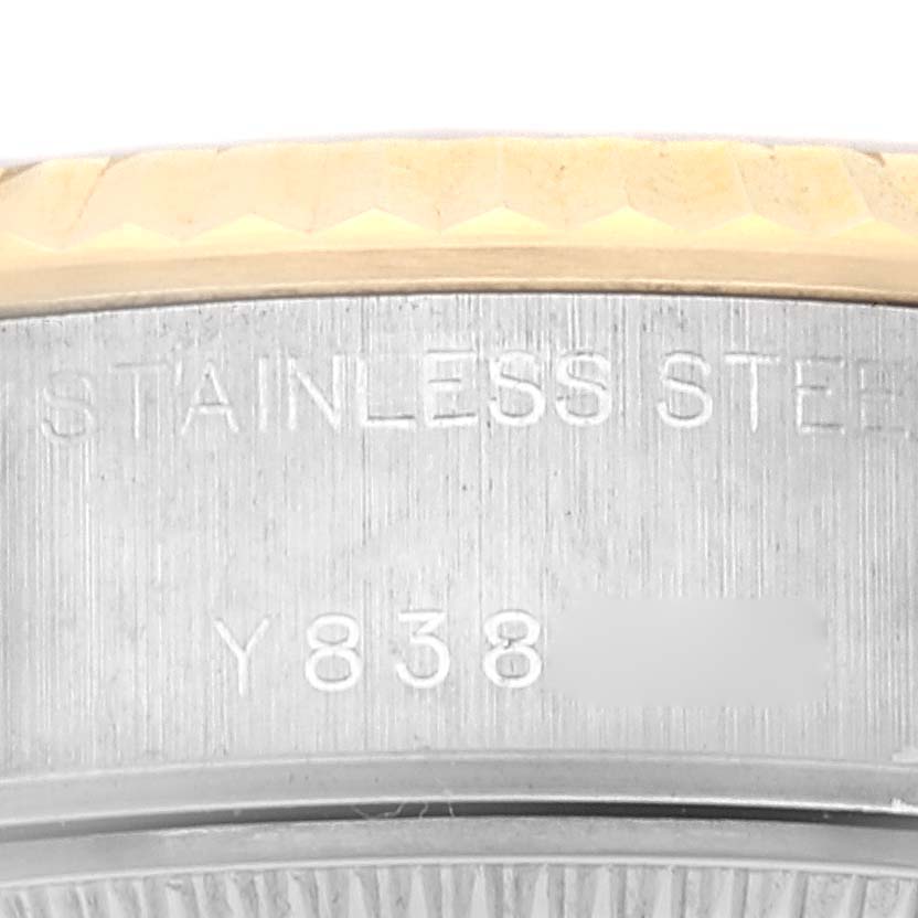 The image shows a close-up angle of the Rolex Datejust 79173 Women's Steel and Gold (two tone) Champagne Dial 79173 Women's Steel and Gold (two tone) Champagne Dial model, focusing on the stainless steel case with engraved text.