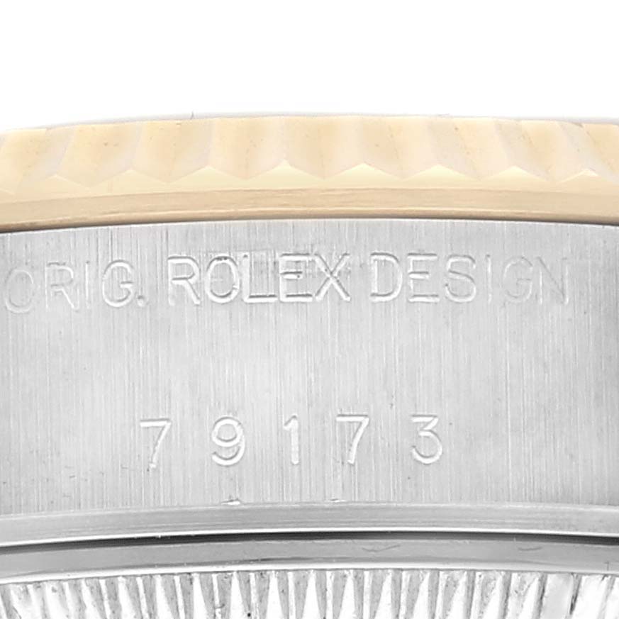 This image shows a close-up of the side of a Rolex Datejust 79173 Women's Steel and Gold (two tone) Champagne Dial 79173 Women's Steel and Gold (two tone) Champagne Dial watch, highlighting the model number 79173 and the inscription "ORIG. ROLEX DESIGN."